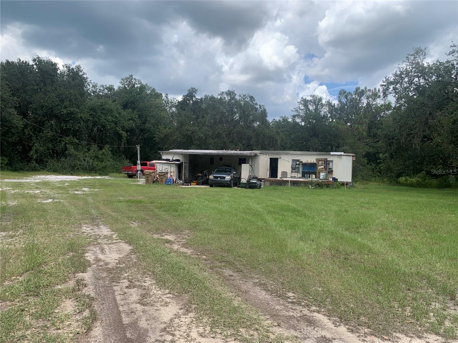 Five acre lot with with electric, well and septic tank in place. Plenty of nice spots to build on. Lots of beautiful trees. Mobile home is not habitable. According to Lake county zoning; some, if not all, of the impact fees will be covered as long as the proper permits are applied for and the correct documentation is made before the mobile is removed. Please verify all this information with the county.