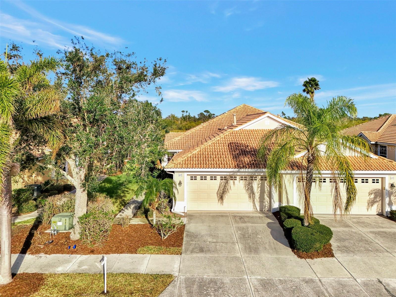 HERON CREEK GOLF & COUNTRY CLUB *TURNKEY FURNISHED *Paired Villa 2BED 2BATH +DEN with panoramic GOLF VIEW (#4 Oaks)! Available for Immediate Occupancy! This former Model is oozing with Coastal Charm, boasts over 1500 sq feet of well-designed living space and is perfectly suited for both seasonal escapes and year-round living! The desirable Bimini floor plan features a spacious open concept great room, versatile DEN/office, split bedroom plan for privacy, a fabulous Island kitchen w/sun filled dining nook and a spacious extended lanai overlooking the lush fairway! From the moment you walk through the beautiful leaded glass door you can’t help but appreciate the chic coastal casual décor and design. This villa surely shows like a model but lives like a home …it is stylish yet comfortable and inviting. Design and décor features include classic crown molding, shiplap and decorative millwork, custom window valances and drapes, decorative lighting and fans, stunning sand washed tile plank flooring throughout the living areas, tray ceilings, unique architectural details and niches, artistic wall treatments and perfectly suited furnishings and coordinating décor! The well-appointed Kitchen has abundant cabinetry and workspace, a NATURAL GAS range and is fully equipped with dinnerware, small appliances & pots and pans. Linens and Towels are also included for both bedrooms so all you really need is your suitcase! This villa could also be a great investment opportunity used as a seasonal rental (MIN RENTAL 3 MONTH). The den features a custom built in desk and workstation perfect for a home office. The Primary suite is bright and cheerful with a large double window and features a great window seat with hidden storage. The ensuite bath has dual vanities, a spacious walk-in shower, clothes closet, separate linen closet and has a tubular skylight that brings in abundant natural light. Guests can enjoy privacy in their own bedroom with adjacent full bath at the front of the home. This beautiful villa is ready to warm your heart just in time for Valentines Day! Heron Creek offers exceptional amenities including a 21,000 sq ft clubhouse, 27 holes of Championship golf Arthur Hills design, resort style pool & spa, a robust social activity calendar, fitness center, Tennis courts & formal & casual dining options! Club Membership is required with 3 membership levels offered beginning at $268/month *NO CDD FEES * LOW HOA FEES include lawn care, trimmings, mulching, irrigation, Cable HIGH-SPEED INTERNET &Gated entry, conveniently located w/easy access to I-75 & US-41, Cocoa Plum Shopping, Myakkahatchee Creek trails, WELLEN PARK, Braves Stadium, COSTCO & new SMH health