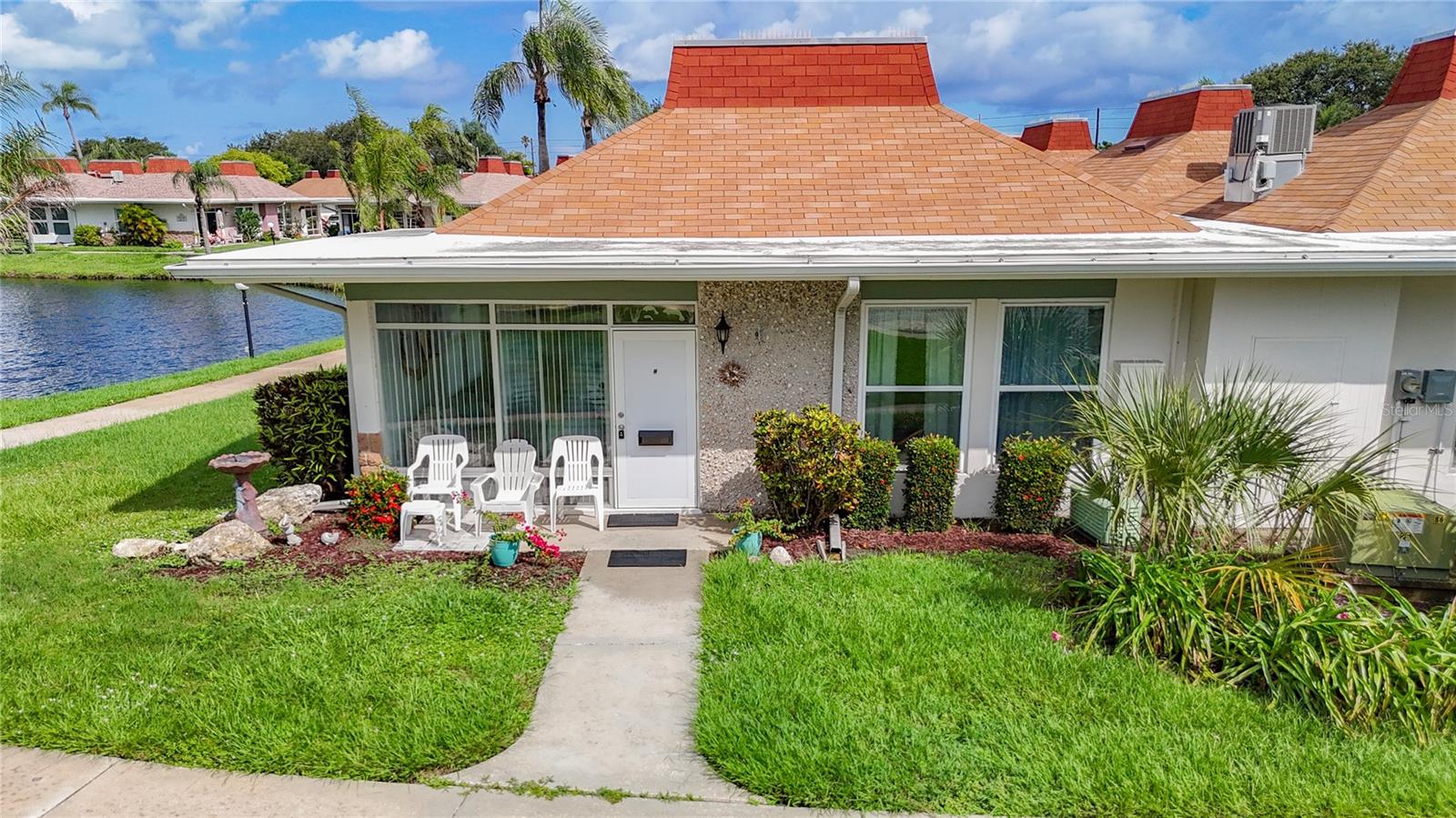 Welcome Home! End-Unit Water View Villa in Tahitian Gardens – Prime Location, Furnished & Move-In Ready. Come and see this highly desirable gated 55+ community of Tahitian Gardens. NO Flood Zone, Low HOA Fee! This rarely available corner unit offers enhanced privacy, peaceful views, and direct access to the community’s scenic walking path—ideal for enjoying Florida’s tranquil lifestyle. Inside, you'll find a bright, open floor plan with a spacious living and dining area that flows seamlessly into the kitchen. The home is being sold fully furnished.
Tahitian Gardens has many activities including shuffleboard, arts and crafts, a bicycling club, bingo, dominoes, card groups and more. Located off US 19 in Holiday, FL with easy access to shopping and public transportation. Tampa and Clearwater airports are less than an hour’s drive. Walking distance to CVS, Walgreens and Aldi. Minutes away from Tarpon Springs, the Sponge Docks and the beach at Howard Park.