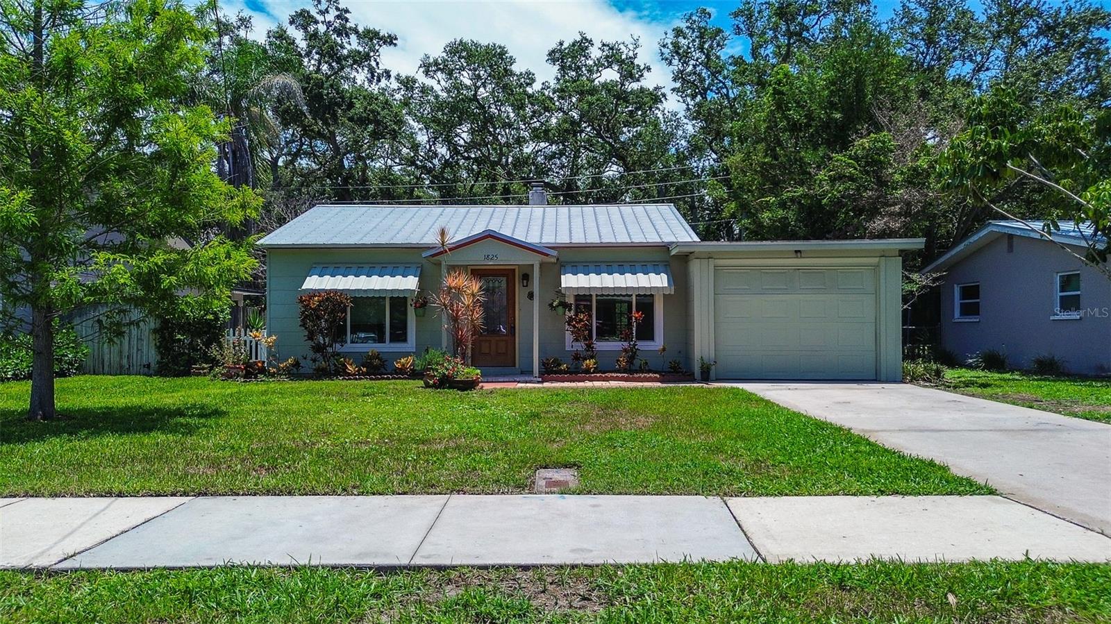 Dunedin Charmer with PRIVATE BACKYARD backing up to HAMMOCK PARK, with 100 acres of nature trails, natural foliage, beautiful birds and butterflies! IT’S LIKE LIVING IN A PARK! Just 2 blocks to PINELLAS TRAIL – bike or stroll to DUNEDIN MAIN STREET with its art and music festivals, lively restaurants and craft breweries! Welcome to this CHARMING COTTAGE IN THE HEART OF QUAINT DUNEDIN with metal roof, cheery sun room and picturesque setting! Step inside and you’ll appreciate the abundance of NEW HURRICANE RATED WINDOWS & DOORS (2021) inviting NATURAL LIGHT to create a warm and welcoming atmosphere. The home boasts NEW VINYL FLOORING (2024) throughout the main living areas, adding a touch of sophistication and easy maintenance. You’ll find 2 Bedrooms PLUS 12x8 BONUS ROOM that could be a HOME OFFICE. Glass Sliders in sun room seamlessly connect the inside to the backyard, providing the PERFECT INDOOR-OUTDOOR FLOW. Outside, the fenced backyard is your private oasis, where you can enjoy Florida evenings on the open patio. Whether you’re sipping your morning coffee or hosting a gathering, this outdoor space is perfect for appreciating the natural beauty surrounding you. The home is beautifully landscaped with a mix of native Florida plants, creating a colorful and inviting atmosphere year-round. The outdoor space is perfect for nature lovers, offering plenty of opportunities for relaxation and outdoor enjoyment. There’s even ROOM TO PARK YOUR BOAT, jet skis or kayak. And No HOA fees, No CDD. Key updates include New AC 2021, New Storm Windows and Doors 2021, Metal roof 2007, roof over garage 2017. Located in the quaint coastal community of Dunedin. Imagine the lifestyle here. This home is NESTLED WITHIN THE DUNEDIN GOLF CART PERIMETER, making it easy to EXPLORE THE COMMUNITY IN A FUN and convenient way. Invite guests over and head out to bustling Main Street to enjoy the city’s vibe! ABSORB THE AMBIANCE OF DUNEDIN’S fine and funky restaurants, eclectic nightlife, craft breweries, galleries and boutiques, craft shows, jazz and blues festivals, cultural events! Enjoy sunsets at the Fenway Hi-Fi Rooftop Bar, activities at Dunedin Marina and Edgewater Park, fishing on the pier or catching a ferry to world famous Caladesi Island and its beach! Quick drive to the sandy shores of Clearwater Beach and Honeymoon Island State Park! This home is just 1 mile to Highlander Park, Dunedin Community Center, Dunedin Fine Arts Center, Ball Fields, Pools, Pickle Ball Courts, Tennis Courts, Amberlea Park dogs allowed, and newly renovated Donald Ross designed Dunedin Golf Club. This is a perfect spot for those seeking the VIBRANT DUNEDIN LIFETSYLE—schedule your private tour today!