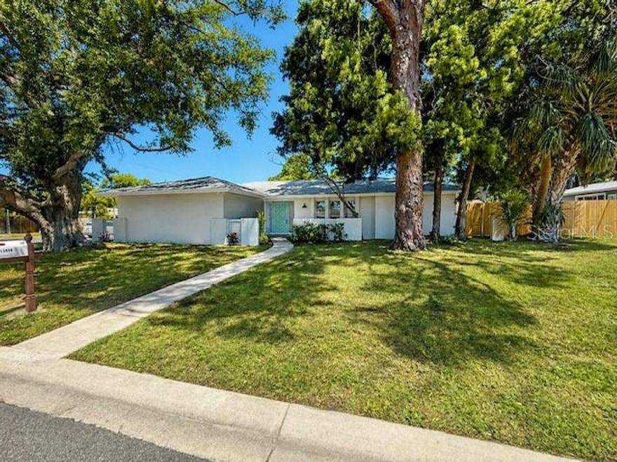 WOW! Just a short walk to the beach! This updated 2-bedroom home with a bonus room (possible 3rd bedroom) sits on an oversized corner lot and features a split bedroom plan for added privacy. The primary suite includes an en suite bath and walk-in closet.

The home offers a spacious layout with separate living and dining areas, plus a large family/bonus room. The renovated kitchen includes quartz countertops, stainless steel appliances, new cabinetry, and a breakfast bar.

Recent updates include new tile flooring throughout, fresh paint inside and out, new HVAC, and a new water heater. Indoor laundry with new washer and dryer and utility sink. Large screened porch and a fenced yard with plenty of space to enjoy the outdoors. 2-car side-entry garage with new opener.

Conveniently located near the beach, dining, and shopping. HIGH & DRY LOCATION! Situated in a non flood zone, no flood insurance required. Plenty of room for Boat and RV parking. Large fenced yard.