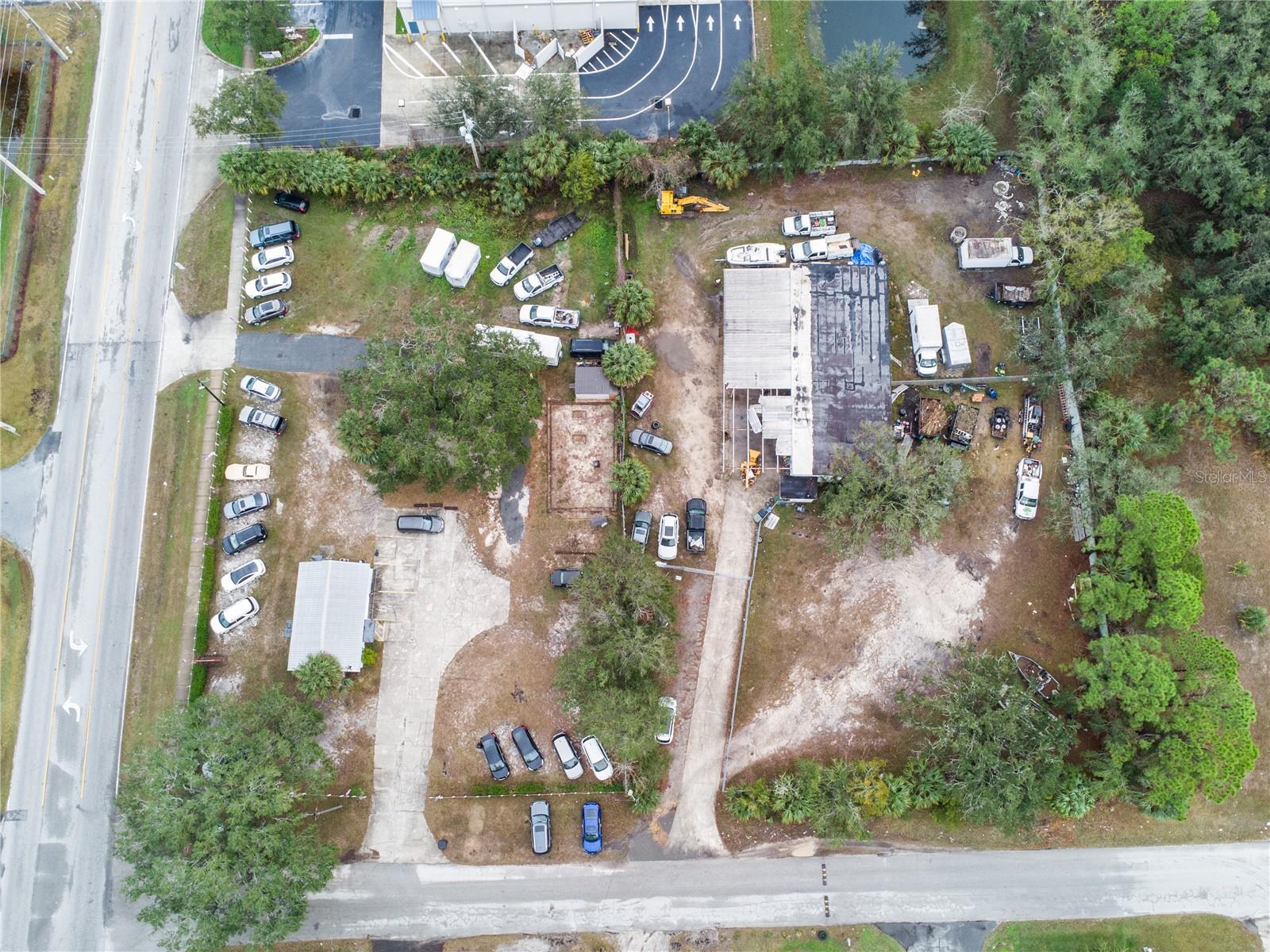 This property is a prime location just off of US 27 in Leesburg. Note there are 2 parcels being sold together. The adjoining parcel at 1226 Penn St. and 1421 Griffin Rd. Total combined acreage is 2.73.
Both parcels are C-3 zoning. Griffin has two entrances and has high visibility. The 660 sq ft building contains a restroom, break room or storage space, and main retail space with large windows all under air. It has a perimeter fence and chain link fence around the lot. Plenty of parking space or room to build here. Penn is currently operating as an auto mechanic repair shop. It sits on 2 acres fully fenced in chain link and the block 1,364 sq ft building contains 3 bays with metal roll-up doors, 2 hydraulic lifts, an office space, handicap restroom, and 2 storage areas. The metal roof and expansive (21x76) awning provide shade and protection from weather elements. The opportunity here is to develop the existing spaces or knock down and build fresh. Come see the possibilities and make it yours.