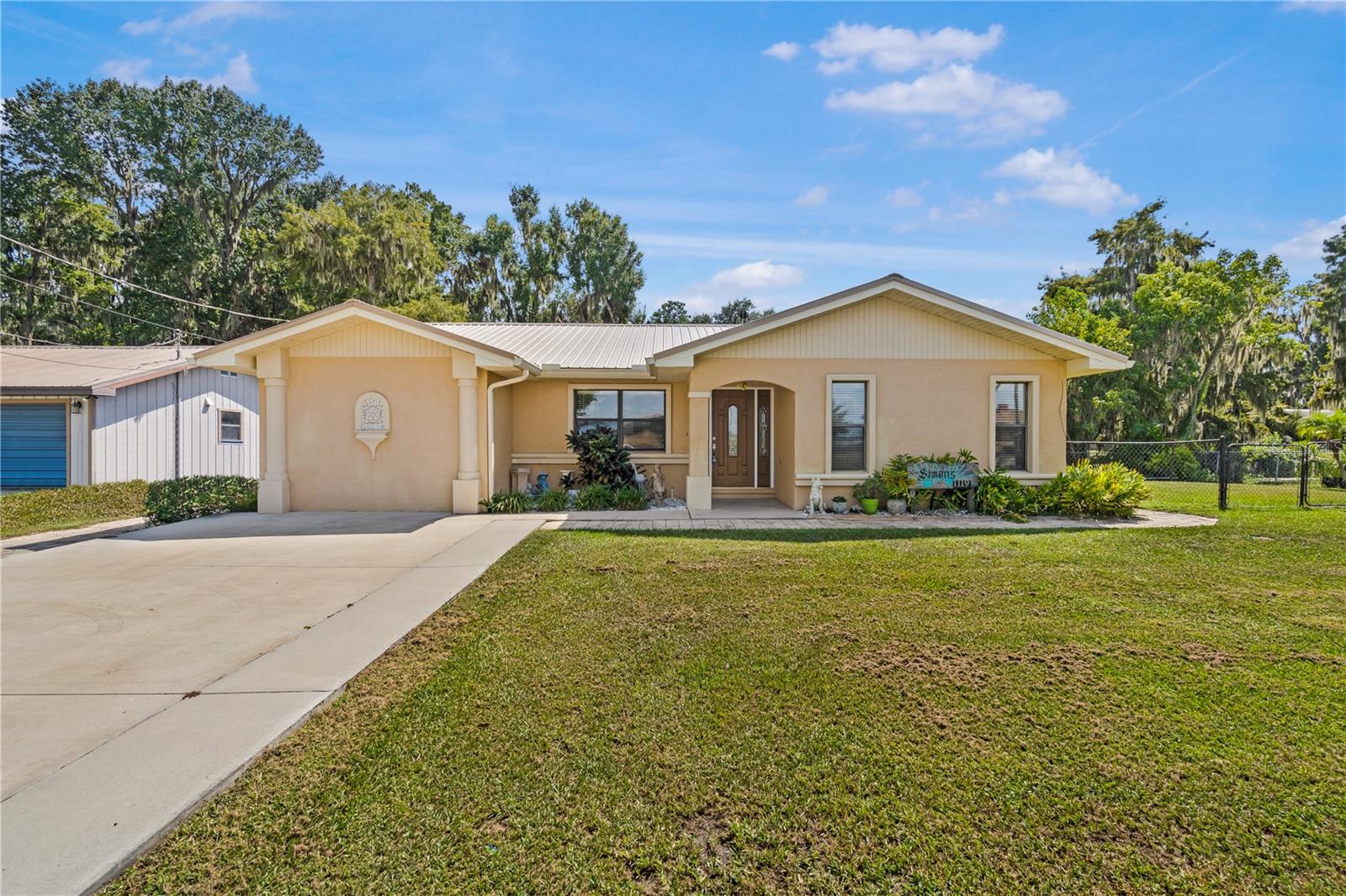 Canal-front charm meets practical comfort in this solid block and stucco home offering approximately 1,758 square feet of living space and set on approx 1/3 acre lot at the end of a quiet street. Featuring two bedrooms, two full bathrooms, and an extended enclosed bonus room. Recent updates include a metal roof installed in 2022 and a new central A/C in 2024 and tile flooring throughout. The updated kitchen includes newer appliances, ready for everyday use. Step outside to a screened lanai perfect quiet relaxation, a spacious back yard with two sheds offering extra storage, and a detached 1-bedroom in-law suite with a private entrance. The property connects to the scenic Lake Panasoffkee via a freshwater canal. Residents also benefit from nearby community amenities, including access to a public boat ramp.