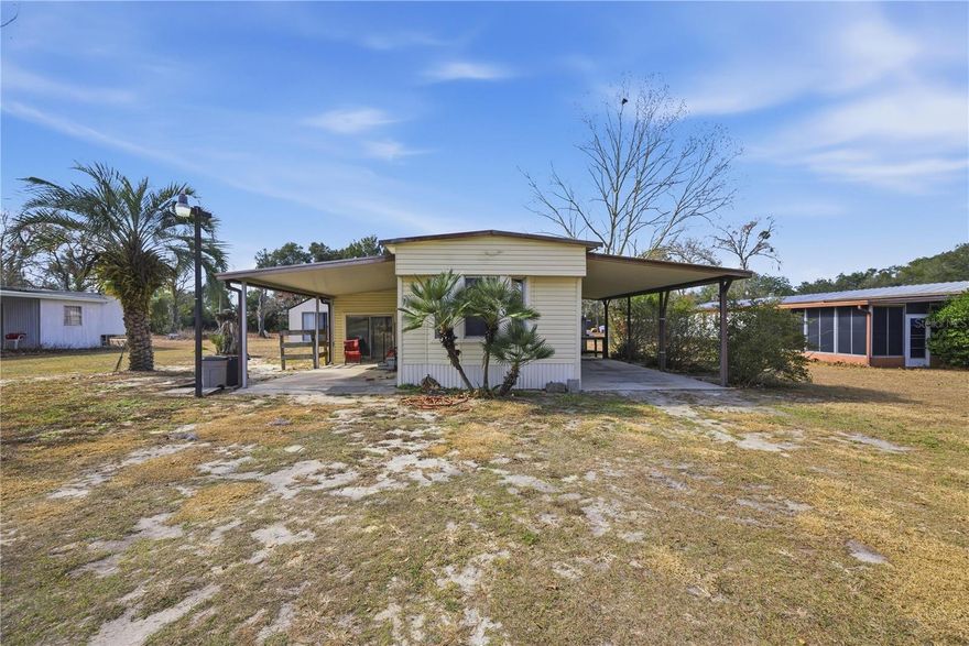 NO HOA! Well-maintained single-wide manufactured home on a spacious over 1/2 acre lot in Summerfield located just mins away from the villages. Featuring an open living room and kitchen layout and a recently updated A/C system. Split bedroom floor plan offers added privacy and natural light. Property is serviced by well water and septic. A standout feature includes two garages plus a separate workshop, providing excellent space for vehicles, storage, or hobbies. Convenient country setting with easy access to shopping, dining, and major roadways.