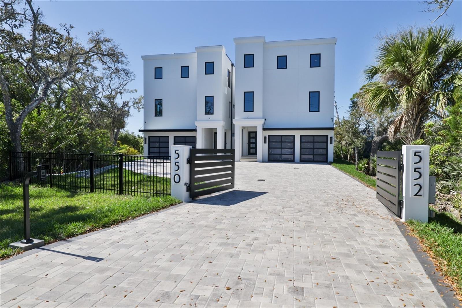 Welcome to this awe-inspiring newly constructed luxurious residence, nestled along the tranquil deep-water Callalisa Canal of New Smyrna Beach. Located in the Central Beachside Hamlet of NSB and includes THREE DEEP WATER DOCKS! This property seamlessly combines sophistication with over 3,700 sq ft of coastal living. Home is situated in Flood Zone X
Featuring 4 generously proportioned bedrooms and 4.5 lavishly appointed baths, this residence stands as a testament to impeccable design and expert craftsmanship. Each bedroom functions as a personal sanctuary, complete with en-suite bath. The spacious living area effortlessly connects to a cutting-edge kitchen, catering to the culinary enthusiast's dreams and an oversized 3rd floor balcony complete with Summer Kitchen.
The Pièce de Résistance of this Estate is the outdoor living area. The third-floor balcony not only boasts a spacious Summer Kitchen, but also serves as an ideal viewpoint for breathtaking sunsets over the canal. Whether hosting gatherings or relishing quiet evenings enveloped by the serene waters, the ambiance is unparalleled.
For avid boaters, this property is without equal, offering 3 Deeded deep water boat slips. One of these slips is equipped with a new 16,000 lb boat lift, ensuring utmost care for your vessel. The direct access to open water, area restaurants, Mosquito Lagoon and Ponce Inlet from your own backyard is truly unmatched.
Additional amenities include an elevator, two-car garage with abundant storage space and meticulously landscaped surroundings that enhance the overall grandeur of the home.
Other important features: Commercial Grade TPO Roof (15-20 year), under ground filtration system that collects and disburses watershed, LOMAR (Letter or Map Revision) flood insurance not required, pavers and electric gate will be installed on the south grass side (each side will have their own drive and electric gate)
Positioned in the heart of New Smyrna Beach, this residence is a rare find, blending opulence, comfort, and a relaxed waterfront lifestyle. It transcends the concept of a mere home; it's a sanctuary for those who seek the extraordinary. One or more photos have been virtually staged. Be sure to watch our Video Tour! When local knowledge is required, insist on local representation.