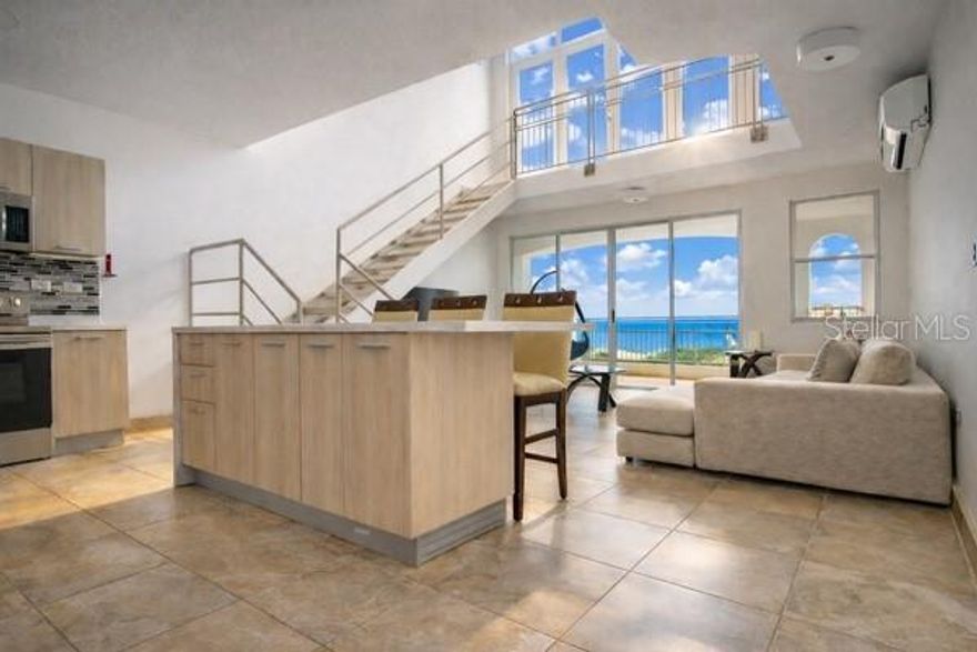 Oceanfront Penthouse Investment Opportunity | Mar Azul, Puerto Rico Perched on the eighth floor of the renowned Mar Azul Condominium, this exceptional oceanfront penthouse represents a rare opportunity to acquire a high-performing coastal asset in one of Puerto Rico’s most desirable beachside communities. Offering 70% owner financing, the property combines immediate income potential with long-term appreciation in a prime west-coast location. Spanning 1,753 square feet across two levels, the residence features three bedrooms and three bathrooms, thoughtfully designed to balance comfort, privacy, and oceanfront living. The open-concept living and dining area flows seamlessly into a fully equipped kitchen and dedicated laundry room, creating an inviting space ideal for both private enjoyment and hosting guests. Currently operating as a successful short-term rental with strong performance, the property benefits from consistent demand from travelers seeking premium accommodations on Puerto Rico’s celebrated west coast. In accordance with HOA regulations, the residence is rented with a 7-night minimum stay, maintaining an elevated guest profile while preserving the tranquility of the community. Ownership also includes two assigned parking spaces, along with the security and reliability of a full emergency generator and water cistern, ensuring uninterrupted comfort year-round. Residents enjoy access to Mar Azul’s resort-style amenities, including a large swimming pool, children’s play area, beach volleyball court, and direct access to a private stretch of pristine beach. The surrounding area is internationally known for its surf breaks, vibrant culinary scene, and relaxed yet sophisticated coastal atmosphere, further enhancing the property’s appeal as both a lifestyle purchase and investment asset. Property Details • Interior Area: 1,753 sq ft • Bedrooms: 3 • Bathrooms: 3 • Parking: 2 assigned spaces • Annual Property Tax: $2,715.33 • Monthly HOA: $289.00 • Owner Financing Available: Up to 70% Whether envisioned as a primary residence, refined vacation retreat, or income-producing investment, this penthouse offers a compelling combination of location, performance, and flexibility. Opportunities of this caliber are rarely available on Puerto Rico’s west coast. Coordinates: 18.3795307, -67.2201749