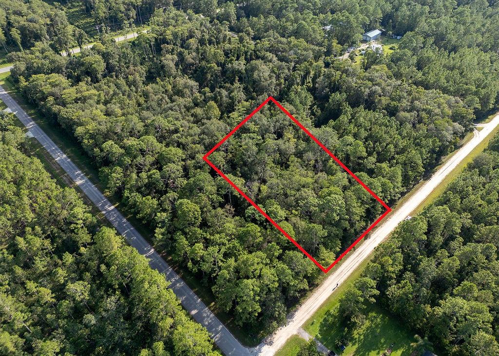 Over 1 acre (165’x300’) wooded lot zoned for manufactured or site-built homes—perfect for your dream home! Bring your farm animals, horses, RVs, work trucks, trailers, or boats—no HOA restrictions. Enjoy the privacy of country living while staying close to shops, restaurants, and just 25 minutes from the beach. Nearby Hidden Trails Park offers recreation, and boat launches on Crescent Lake and Dead Lake provide endless outdoor fun.