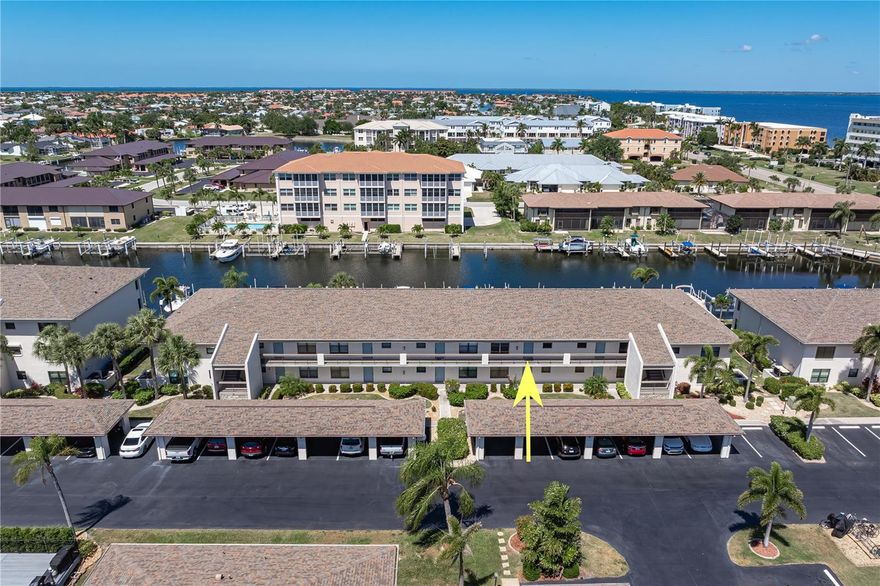 TURNKEY WATERFRONT CONDO W/DEEDED DOCK & SUNSET VIEWS IN PGI - This top-floor 2 bed/2 bath unit at Bridgepoint Condominiums in Punta Gorda Isles delivers the ideal blend of low-maintenance living and immediate boating access. Enjoy quick trips to Charlotte Harbor through Bass Inlet Canal. It's perfect for those ready to spend more time on the water and less time getting there. Deeded dock #17 is just steps away, offering convenient access right behind the building. Inside, the open-concept layout is enhanced by soaring cathedral ceilings, creating a light, airy feel throughout the main living space. Wood-look laminate flooring runs through the great room, complementing the coastal design. The living and dining areas flow seamlessly to the screened lanai, where western rear exposure sets the stage for unforgettable sunset views over the canal and your private dock. A built-in wet bar adds a functional touch for entertaining. The split-bedroom floor plan provides privacy for both owners and guests. The master suite offers an oversized walk-in closet, private en-suite & walk-out access to the lanai, while the guest bedroom and bath are well-positioned for visiting friends or family. Offered turnkey furnished, this condo is ready for immediate use. Perfect as a seasonal getaway, downsizing opportunity, or income-producing investment. Additional features include hurricane protection and two assigned parking spaces, including a covered carport. Bridgepoint amenities support an active, social lifestyle with an in-ground, heated pool, shuffleboard courts, and a multi-use court for tennis, pickleball, and basketball. The community’s prime location places you just minutes from Fishermen’s Village, the Harborwalk, parks, dining, and historic downtown Punta Gorda. Start living the active life you're dreaming of here - miles of sidewalks connect you to historic Punta Gorda, nearby Isles Yacht Club, St Andrews South golf club & the rest of Punta Gorda Isles. Although Punta Gorda is known for boating and fishing, there is also an active art & music scene with frequent festivals and weekend fairs. There is truly something for everyone here. Complex is PET FRIENDLY - allowing up to two pets with NO WEIGHT LIMIT. Discover why Punta Gorda is consistently rated as one of the best places in SW Florida to live. Make an appointment today.