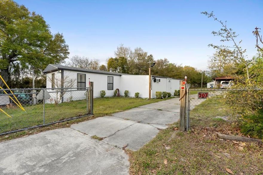 Welcome to this newly remodeled, fully fenced dwelling situated on nearly HALF an acre. This acreage includes two .24 acre lots, both of which are fully equipped with water, septic and electric. Natural lighting provided by a bay window in the kitchen is just one of the charming features of this home. The large Florida room and huge deck emanates what Florida living is about. There's plenty of shelter and storage space with the shed and 2-vehicle carport. Schedule a showing today so you can see why this North Deland property should be yours.