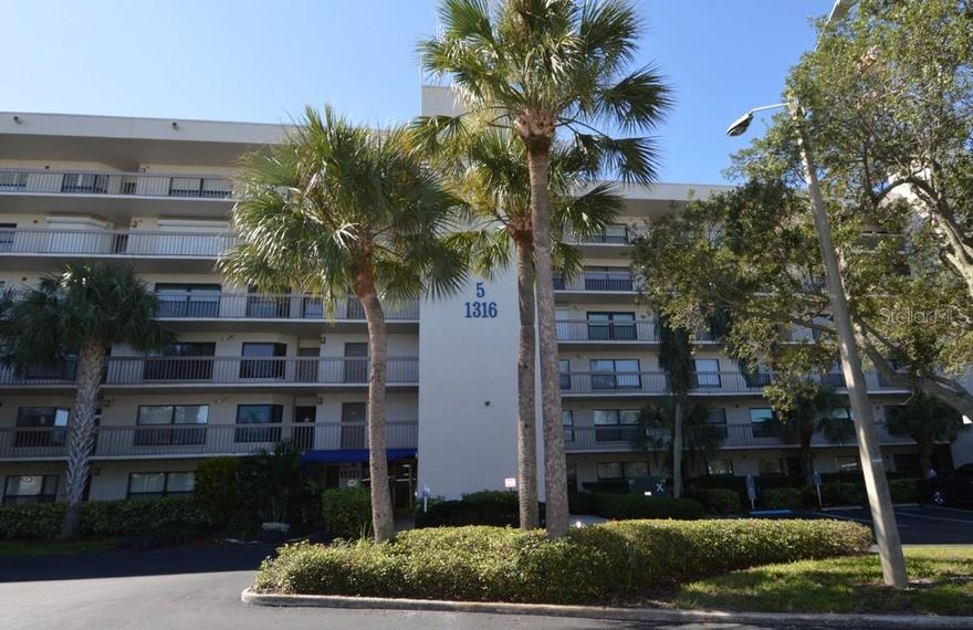 This FULLY FURNISHED beautifully updated Two-Bedroom Two-Bathroom condo INCLUDES A SEPARATELY DEEDED BOAT SLIP (14'x40') and has GORGEOUS WATERFRONT VIEWS.  Excellent investment with a STRONG RENTAL HISTORY.  Pasadena Cove is a fantastic RESORT-LIKE WATERFRONT gated community with a private marina, pool, hot tub, fitness center, clubhouse, billiard table, shuffleboard courts, and walking paths.  Enjoy a protected harbor and private marina with immediate access to Boca Ciega Bay, Tampa Bay, and the Gulf Coast. Your investment is protected by HURRICANE SHUTTERS and IMPACT WINDOWS. The condo also benefits from a completely NEW HEAT/AC SYSTEM (2024) and NEW APPLIANCES (2023 Washer/Dryer, 2024 Dishwasher and Microwave). The kitchen has updated cabinets and counter tops, tile backsplash and breakfast nook. The alley kitchen passes through to the dining and living room. The living room includes a giant smart TV and sound bar on a tilting/swivel arm mount and off the living room are sliding glass doors that lead to a screened-in Balcony/Lani with breathtaking WATERFRONT views of Boca Ciega Bay. High ceilings throughout, plenty of closet space and a full-size washer & dryer in a dedicated laundry closet. This condo is a split bedroom floor plan with a huge master bedroom (King) with walk-in closet, large windows with a gorgeous view, and private access to the balcony. Master bathroom has a large vanity and updated tile shower. The 2nd bedroom (Queen) and 2nd bathroom has an updated tile shower as well and both bathrooms have new toilets (2023).  The assigned carport is near the building entrance, and the newly refurbished elevator provides easy access to the 4th floor condo which enjoys a separate secure storage area and a common bike storage room on the same floor.  It is located only 1.5 miles from ST PETE BEACH and 3 miles from TREASURE ISLAND. Downtown St. Petersburg is a 15-minute drive or take the Sun Runner express bus. There is a Pasadena Cove private pedestrian gate that provides immediate walking access to shopping, and other essentials.