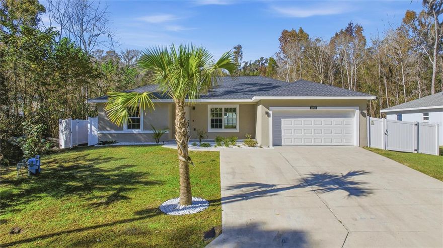 Discover this beautifully maintained 2022-built home that delivers modern style, thoughtful upgrades, and exceptional value. This 3-bedroom, 2-bathroom residence offers the same sleek design and high-end finishes you’d expect from new construction but with added features and a better price point. From the moment you arrive, you’ll notice the extended driveway, perfect for extra vehicles, guests, or work trucks, along with a two-car garage featuring a custom epoxy finish and matching epoxy entry. Fully fenced and gutters are already installed, adding practicality and long-term protection. Inside, the home showcases luxury vinyl flooring throughout, an open-concept layout, and contemporary finishes that create a bright, welcoming atmosphere. The gourmet kitchen is a true standout with quartz countertops, a waterfall island, soft-glow cabinetry, and modern lighting and fixtures ideal for both entertaining and everyday living. The spacious bedrooms are thoughtfully designed, while the bathrooms feature stylish tile work, modern fixtures, and elegant shower finishes. The primary suite serves as a private retreat, complete with a luxurious walk-in shower fully tiled from top to bottom. Step outside through the sliding glass doors to enjoy a long, beautifully paved patio, perfect for cookouts, relaxing evenings, or hosting friends and family. The patio is professionally finished and spacious, offering excellent outdoor living potential. The quarter-acre lot, vinyl fencing, and built-in exterior lighting tucked under the roofline on every corner provide both privacy and added security with a warm nighttime glow. With no HOA or CDD fees, this home offers freedom and affordability. This is a rare opportunity to own a modern, move-in-ready home with upgrades already completed schedule your private showing today before it’s gone!