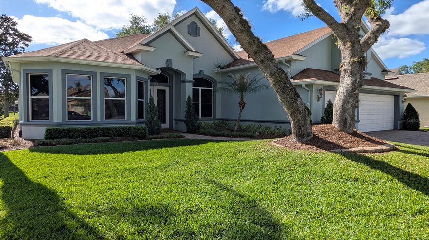 This stunning, spacious four-bedroom house is situated in the sought-after gated community of Hampton Hills Estates within the DeBary Golf and Country Club area. Nestled on a tranquil cul-de-sac, the home overlooks the water. It boasts a generously sized Great Room that flows into a formal dining area and kitchen. Additionally, there is an Office/Den/Library accompanied by French doors. The Master Bedroom Suite features a roomy walk-in closet with built-in enhancements and a Master Bathroom equipped with dual vanities, a jetted bathtub, and a separate walk-in shower. The split-layout includes two more bedrooms and a full bath on the first floor, with a sizable bedroom located upstairs. Among the numerous amenities are a spacious covered and screened lanai perfect for entertaining, which overlooks the pond in Hampton Hills Estates, a three-car garage with built-in cabinets, and a large paved driveway. The open floor plan offers water views from the entryway and continues through the living area and kitchen. The upgraded kitchen features 42-inch wood cabinetry, granite countertops, and essential appliances like a microwave, smooth-top range with convection oven, dishwasher, and refrigerator. The ceilings reach heights of 12 feet and 10 feet throughout, with 8-foot doors. This location is conveniently close to I-4, shopping centers, medical services, a hospital, Sun Rail, bus routes, schools, parks, and nature trails.