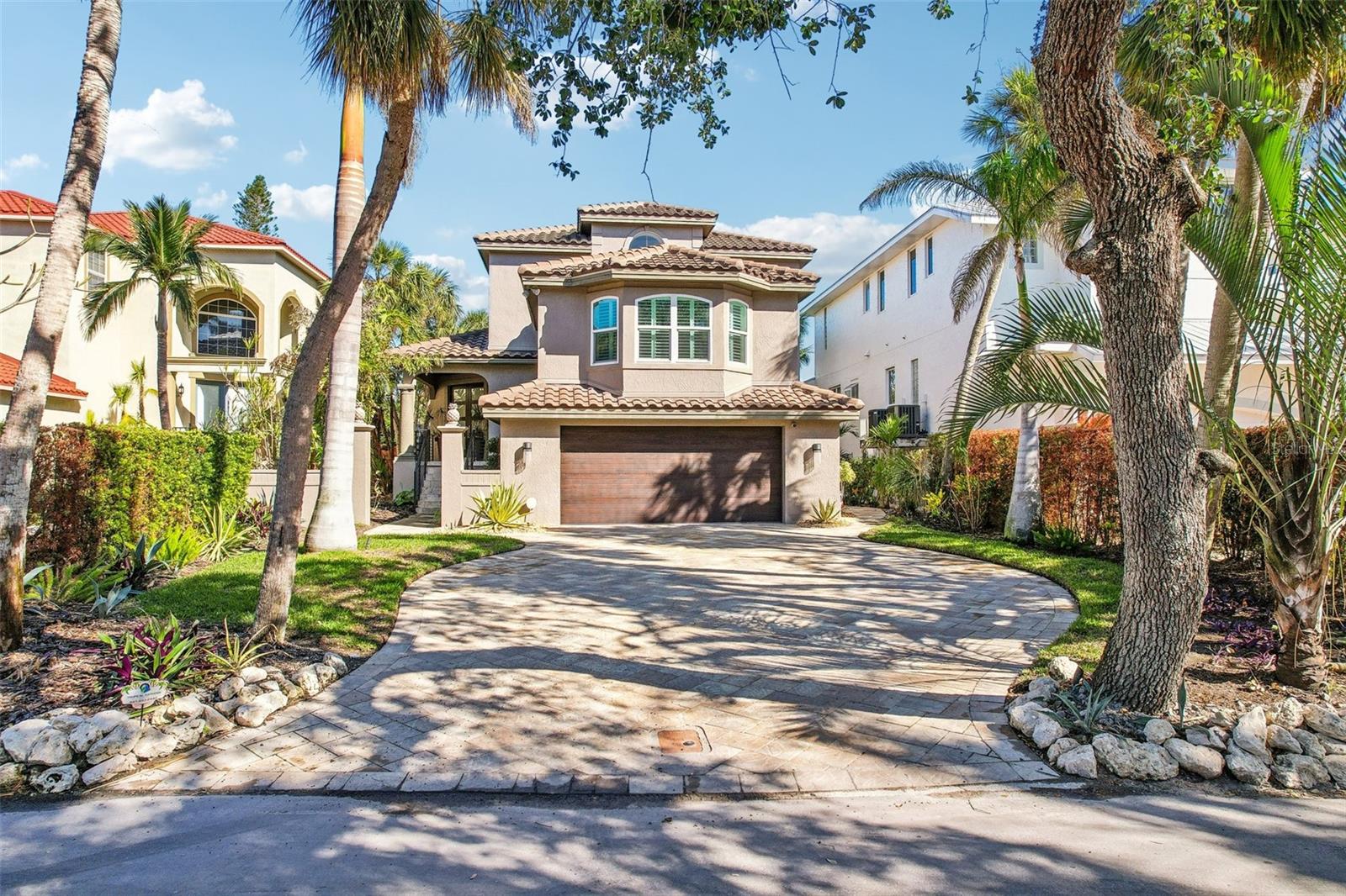 The best value for amenities offered anywhere on Siesta Key - elevated, hurricane-safe, and with a pool and boat lift! Welcome to your dream waterfront oasis, nestled in the heart of Siesta Key, FL. This exquisite home, featuring 3 bedrooms and 4 baths across 2,692 square feet of elegantly remodeled living space, is a true testament to luxury and comfort. Ideal floor plan for AIRBNB with 3 ensuite bedrooms over three floors and one extra full bathroom. Extensive recent renovations, estimated at over $250,000, include a new roof installed in 2019, updated AC units, hurricane-impact windows and doors for peace of mind, and Bahamian shutters that lend a touch of tropical elegance. The property sits at a 9’ elevation according to the most recent elevation certificate and has withstood all recent storms impeccably, ensuring security and resilience. The interior radiates sophistication, with an open-concept main level adorned with crown molding, stone, and shiplap accents. The gourmet kitchen, equipped with top-of-the-line KitchenAid appliances, flows seamlessly into the living and dining areas, which open onto a covered travertine-tile porch—perfect for indoor-outdoor living.
Wake up each morning in one of two luxurious primary bedroom suites. The mid-level suite is perfect for visitors, while the expansive top-floor suite offers a serene retreat. This top-floor suite includes a large walk-in closet, a dedicated purse closet, an en-suite bathroom with a grand shower and separate soaking tub, and a private balcony overlooking the tranquil Grand Canal and the glistening pool below. A third bedroom with its own private bathroom provides a chic and cozy sanctuary for guests or family members. With all three bedrooms functioning as their own suites, the property is also perfectly set up to serve as an income-producing Airbnb or VRBO rental.
Step outside to your private paradise: a renovated waterfront pool with both a heater and chiller for year-round enjoyment. The property also features a composite deck and dock, updated in 2017, complete with a 10,000-pound electric lift—ideal for endless water adventures. With no HOA fees and a location just minutes from Siesta Village and the award-winning Siesta Key Beach, this home offers unparalleled convenience and leisure.
This property is more than a home—it’s a lifestyle. With every detail meticulously upgraded and every corner designed for enjoyment, 5159 Oxford Dr is where your waterfront dreams become reality.