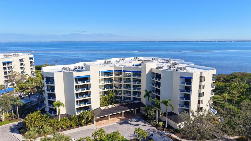 Indulge in spectacular, fully reimagined waterfront living in this extraordinary corner Penthouse residence overlooking Sarasota Bay, where elegance, serenity, and coastal grandeur converge.  Wrapped in breathtaking panoramic vistas from three sides, this rare offering showcases shimmering turquoise blue bay waters, graceful sailboats gliding by, and the delightful sight of dolphins at play – an ever changing masterpiece just beyond your windows. Nestled within the lush, tropical sanctuary of The Atrium at Fairway Bay on coveted Longboat Key, this rarely available 2,500 square foot end unit is a luminous expression of refined luxury.  Designed to inspire, the residence offers two generous bedrooms, two spa-like baths, and a grand office/den enhanced with custom built-ins perfect for a refined workspace or private retreat (easily converted to third bedroom by adding closet doors). An expansive, oversized balcony invites effortless indoor-outdoor living, ideal for morning sunrises and evening sunsets over the Bay. Every detail has been meticulously curated for modern luxury and peace of mind. The completely remodeled kitchen and baths feature high-end designer finishes, while stunning new hard maple wood flooring flows seamlessly throughout the main living areas. A whole-home water filtration system, hurricane shutters, and immaculate, neutral décor ensure comfort, security, and timeless sophistication.  This exclusive gated community residence includes two dedicated parking spaces, an oversized private storage unit, and a secure, private garage. Enter through a keyed, atrium style lobby, where soaring palms and lush tropical foliage create a resort-like welcome every day. Residents enjoy an exceptional suite of amenities, including a heated resort pool and spa, tennis and pickleball courts, a state-of-the-art fitness center, and private access to the Bay Isles Beach Club directly across the street on the Gulf side of Longboat Key – delivering the quintessential Floridian lifestyle.  Perfectly positioned near fine dining and boutique shopping on Longboat Key and St. Armands Circle, Sarasota’s renowned cultural and culinary scene, Harbourside Golf Course, Longboat Key Moorings Marina, boating, fishing, and abundant guest parking, this remarkable penthouse offers an unparalleled year-round residence or a truly exquisite seasonal retreat – where luxury, lifestyle, and location unite in flawless harmony.