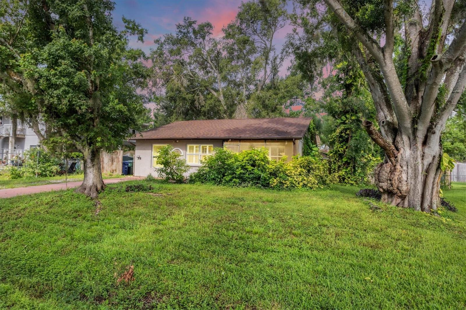 LOCATION, LOCATION, LOCATION...NO HOA RULES, NO HOA FEES, NO DEED RESTRICTIONS, NO WATER/SEWER BILL, Roof is only 6 years old, HVAC is 6 years old. Welcome home to this quaint 3 bedroom, 2 bath home with an updated kitchen featuring white cabinets and granite counters, plantation shutters, tile throughout main living areas, an office nook, a screened front porch and a screened lanai in the back. There is a large shed in the back yard. The home is on well and septic so there are no water/sewer bills to pay. Private back yard with lots of shade trees and the home is situated on almost 1/4 acre and is on septic and well. $350,000