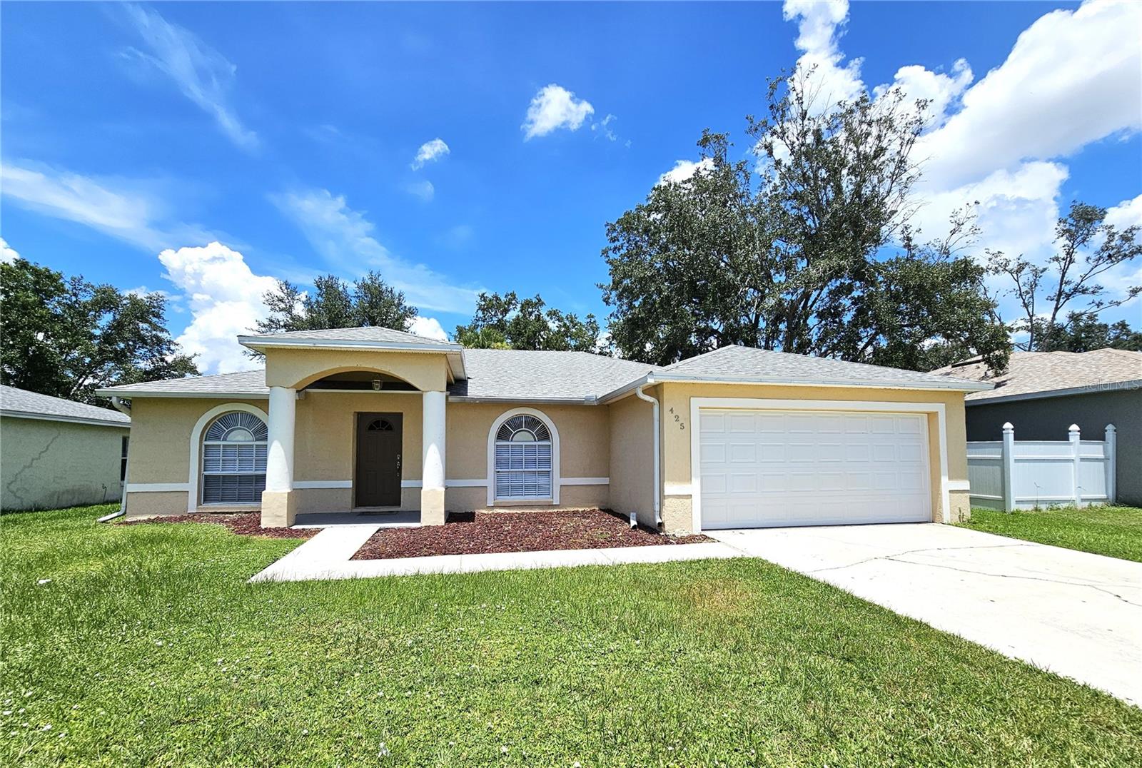 Beautifully maintained 3-bedroom, 2-bath home in Poinciana North Village, this property features New carpet, a freshly painted interior and a brand-new roof installed in 2023, offering peace of mind for years to come. The interior boasts an inviting open-concept layout with vaulted ceilings and a true split-bedroom floor plan. The gourmet eat-in kitchen includes granite countertops, a built-in dry bar, and higher-end stainless steel appliances, including a refrigerator, stove, microwave, and dishwasher. Top-of-the-line front-load washer and dryer are also included, making this home truly move-in ready. The great room is spacious and filled with natural light, and each room is enhanced with upgraded lighting, faucets, and ceiling fans. The primary suite offers a generous walk-in closet, a luxurious garden tub, a separate walk-in shower, and dual granite vanities—creating a spa-like retreat. Step outside to enjoy a large fenced backyard that’s perfect for entertaining, family gatherings, or simply relaxing in privacy. The covered and fully screened patio extends your living space and invites year-round enjoyment of the Florida lifestyle. Located near shopping centers, restaurants, schools, parks, and a brand-new hospital, this home offers convenience and connectivity to everything you need. Whether you’re a first-time buyer, a growing family, or an investor seeking a high-quality rental, this property checks all the boxes.