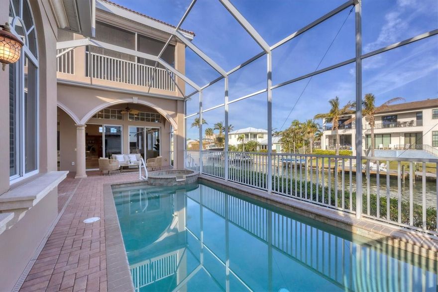 Welcome to the coastal sanctuary you've been dreaming of—perfectly nestled on a peaceful cul-de-sac in one of Longboat Key’s most coveted communities, Country Club Shores. Set on an oversized, lushly landscaped lot, this elegant waterfront residence offers mesmerizing Sarasota Bay views and a front-row seat to the city skyline, all from the comfort of home. Step inside and immediately feel the sense of space and serenity. Soaring 12-foot ceilings, custom crown molding, and a seamless blend of travertine tile, rich wood flooring, and plush carpeting create a warm, luxurious ambiance throughout. Sunlight dances through the open floorplan, illuminating every corner with a golden glow that shifts with the setting sun. Designed for both effortless living and stylish entertaining, the expansive living and dining areas are the heart of the home. Picture evening cocktails or other beverages as the sky blushes in brilliant pinks and oranges, or cozy mornings with coffee or tea as the bay sparkles just beyond your lanai. Your private outdoor oasis features a screened retreat with a heated pool and spa—perfect for moonlit swims or lazy afternoons under the palms. Whether hosting guests or savoring a quiet moment alone, this space transforms every day into a vacation. At the center of it all is a chef’s kitchen that blends beauty with function. Granite countertops, custom wood cabinetry, a double wall oven, generous counter space, and a walk-in pantry make it a culinary dream. Prepare meals, bathed in natural light. it’s inspiration in every direction. Additional thoughtful features elevate this home beyond expectations: custom-built walk-in closets and office cabinetry for impeccable organization; three HVAC systems and water heaters for year-round comfort; three air-conditioned storage rooms plus a third-floor bonus space; fresh exterior paint and an oversized garage with a circular driveway. And just beyond your doorstep? Paradise. Enjoy deeded access to a private Gulf-front beach, where soft white sand and turquoise water are your playground. Nearby golf courses, boutique shopping, and world-class dining enhance the luxury lifestyle. Prefer the outdoors? Biking, boating, and tranquil nature trails await just minutes away. This is more than a home. It’s a daily escape. A statement. A lifestyle. And now—offered at an incredible new price—this opportunity won’t last. Your waterfront dream is waiting. Come live it.