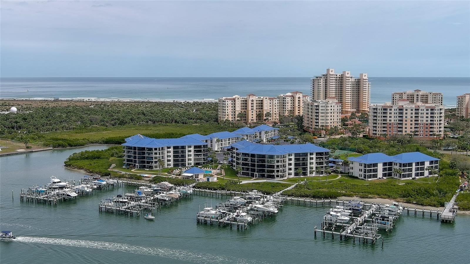 Inlet Marina Villas is a small riverfront community with a private clubhouse, riverfront summer kitchen & cabana, pool, BBQ grills, tennis & pickleball courts adjacent to a marina with boat slips & fishing docks. Situated next door to the 220 acre Smyrna Dunes Park which has 2 miles of boardwalks to the beach & the river & a dog friendly beach area! Immaculate & tastefully furnished, this 2BR/2BA ground floor condo includes a reserved covered carport just steps to your front door & a spacious screened balcony with large storage closet. Special features of this corner unit include 2 bay windows in both bedrooms which provide lots of natural sunshine & both have ensuite bathrooms. Enjoy the best of both worlds living on the river with spectacular views of sunsets, boating action & marine life plus private gated access to the beach through Minorca property across the street. The community has been recently renovated including new windows in 2022, a new roof in 2023 & has completed both inspection reports & are fully funded. Enjoy the heated pool plus riverfront clubhouse with summer kitchen, gas grills, fire pit, tennis and pickle ball courts, kayak/paddleboard storage and rest rooms. The Marina offers boat slips for rent, which feature electric, water, two fish cleaning stations & some of the best fishing since it is right next to Ponce Inlet. There is a wait list at this time for a slip, but you can still enjoy the docks for fishing & watching the boats sail by. Ride your bike or golf cart to the famous Flagler Ave just 2 miles away with bustling nightlife, restaurants and shopping. Enjoy the Florida lifestyle today that you deserve!