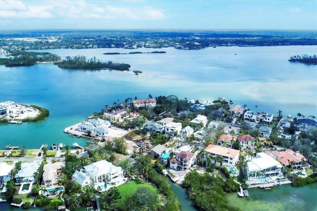 Discover an exceptional opportunity to own a meticulously maintained 4-bedroom, 3-bathroom home in Roberts Point, a prime North Siesta Key location. This two-story residence offers endless possibilities—whether you choose to move in, renovate, or rebuild to create your dream retreat. Designed for entertaining, the home features a hot tub and multiple outdoor living spaces and decks overlooking the bayou, providing the perfect setting to relax and enjoy time with friends and family. This property offers the potential for a dock, providing easy access to the bayou and beyond. The primary living area is on the second level, boasting an open and inviting layout with soaring vaulted ceilings. The ground level includes a two-car garage, a private 1-bedroom, 1-bathroom suite, a bonus room, and a screened lanai, making it an ideal space for guests or additional living quarters. Enjoy peace of mind with a new roof (August 2023), hurricane shutters, and recent storm remediation. Experience the beauty of Siesta Key with direct water access, lush surroundings, and the convenience of being just minutes from the beach, shopping, and dining. Don’t miss this rare opportunity to own a slice of paradise—reimagine or rebuild in this unbeatable location!