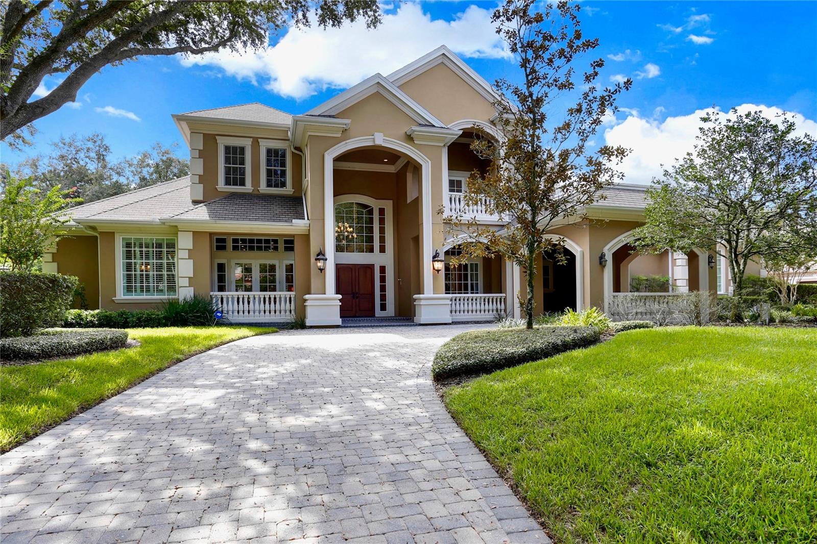 Stunning Custom-Built Estate in Avila – Tampa Bay’s Premier Gated Golf and Country Club Community. Welcome to this beautiful two-story estate located in the prestigious, guard-gated community of Avila. Built in 2005, this custom-designed residence offers timeless elegance, superior craftsmanship, and over 6,000 square feet of luxurious living space. This exceptional home features 6 bedrooms, 5 full baths, 2 half baths, a private guest house, home office, loft, and a gated motor court leading to a spacious four-car garage. The guest house—serving as the sixth bedroom—is complete with its own living room, kitchen, bedroom, and full bath, ideal for visitors or multi-generational living. A dramatic porte-cochère entry sets the tone for the elegance that continues throughout the home. Inside, you'll find granite countertops, custom wood cabinetry, Brazilian cherry wood and marble flooring, coffered ceilings, and intricate crown moldings that showcase attention to every detail. The gourmet kitchen is a chef’s dream, featuring a Dacor 6-burner gas cooktop, double ovens, two dishwashers, and a walk-in pantry, all opening to the warm and inviting family room with custom built-ins and a wet bar, perfect for entertaining. The luxurious first-floor primary suite offers a peaceful retreat with a sitting area with fireplace, morning bar, and a spa-like master bath designed for relaxation and privacy. The home office/library features elegant built-ins and French doors that open to a private patio, creating the perfect space to work or read in peace. Upstairs, you’ll find four generously sized bedrooms, three bathrooms, and a spacious loft with a balcony that overlooks the serene screened-in pool and outdoor living area. Designed for year-round enjoyment, the outdoor spaces include multiple covered seating areas, a resort-style pool, and a private backdrop of lush landscaping. Discover the pinnacle of luxury living in Avila, where privacy, security, and an unrivaled lifestyle await you.