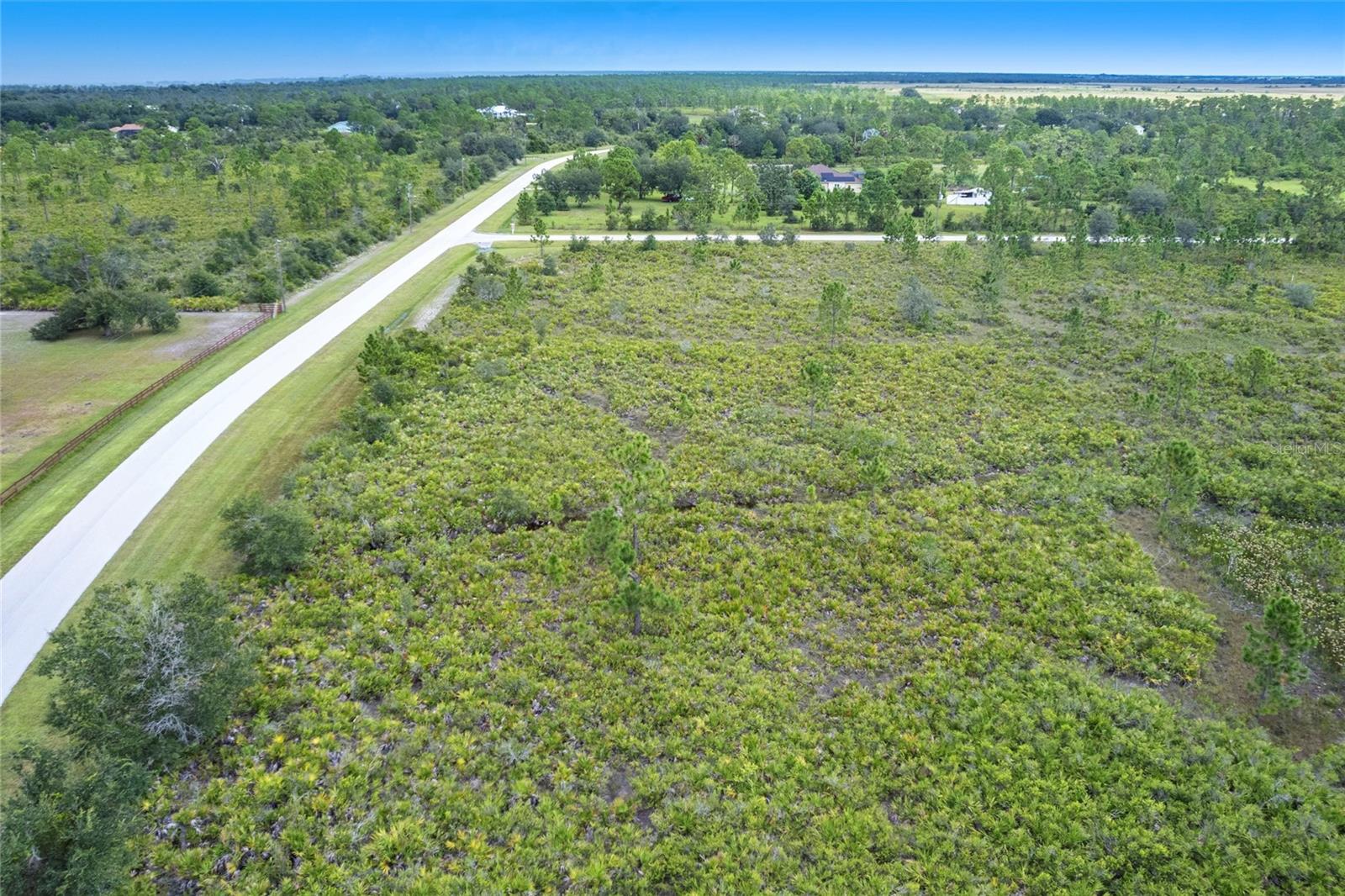 Welcome to 5.11 acres of peaceful, high-and-dry land in Prairie Creek Park, one of Punta Gorda’s most loved equestrian neighborhoods. This gated community is perfect for those who dream of space, privacy, and a quiet country lifestyle while still being just minutes from downtown. Build your custom home here and enjoy wide open skies, sunsets, and nature right outside your door. You can have up to five horses, ride on over 22 miles of trails, and relax knowing you’re surrounded by over 600 acres of groves and conservation land, low HOA; this land is ready to become your home base. Prairie Creek Park is known for its estate-sized properties, winding paved roads, and friendly neighbors who love the outdoors. Just a short drive brings you to Fisherman’s Village, Charlotte Harbor, the Sunseeker Resort, golf, shopping, parks, and even the airport. Whether you’re ready to build now or planning for the future, this homesite gives you a rare chance to enjoy both peace and convenience. Don’t miss out on your chance to live in one of Southwest Florida’s most special places, where horses, trails, and beautiful land come together.