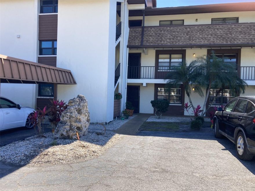 This is an extremely nice spacious second floor three bedroom-two bath turnkey furnished condo located in the 55+ community of Timber Creek.  The condo has been updated with tile floors through out and a beautifully remodeled kitchen.  The kitchen features Granite countertops, white cabinets,  stainless steel appliances, wine cooler and pantry with slide out drawers - and lots of counter space!  The kitchen also has recessed ceiling with can lighting and ceiling fan. The master bedroom is very large, 20x11, and the master bathroom has been updated with walk-in shower, dual sinks and a large walk-in closet.  There are two other bedrooms and an updated second bath - one bedroom has a walk-in closet.  There is large glass/screen enclosed lanai with storage closet housing a full size washer and dryer.  Very quite setting, located at the back of the community and across from one of the greens and fairway.  There is an elevator in the building. Carport. Roof new in 2023. The community has a clubhouse with two kitchens, library, billiard room, gathering room and exercise room.  There is a heated pool and spa, tennis court, pickleball court and shuffleboard.  Plus there is a 9 hole par 3 golf course.  The complex is close to restaurants, groceries and shopping and about 5 miles to the beach.