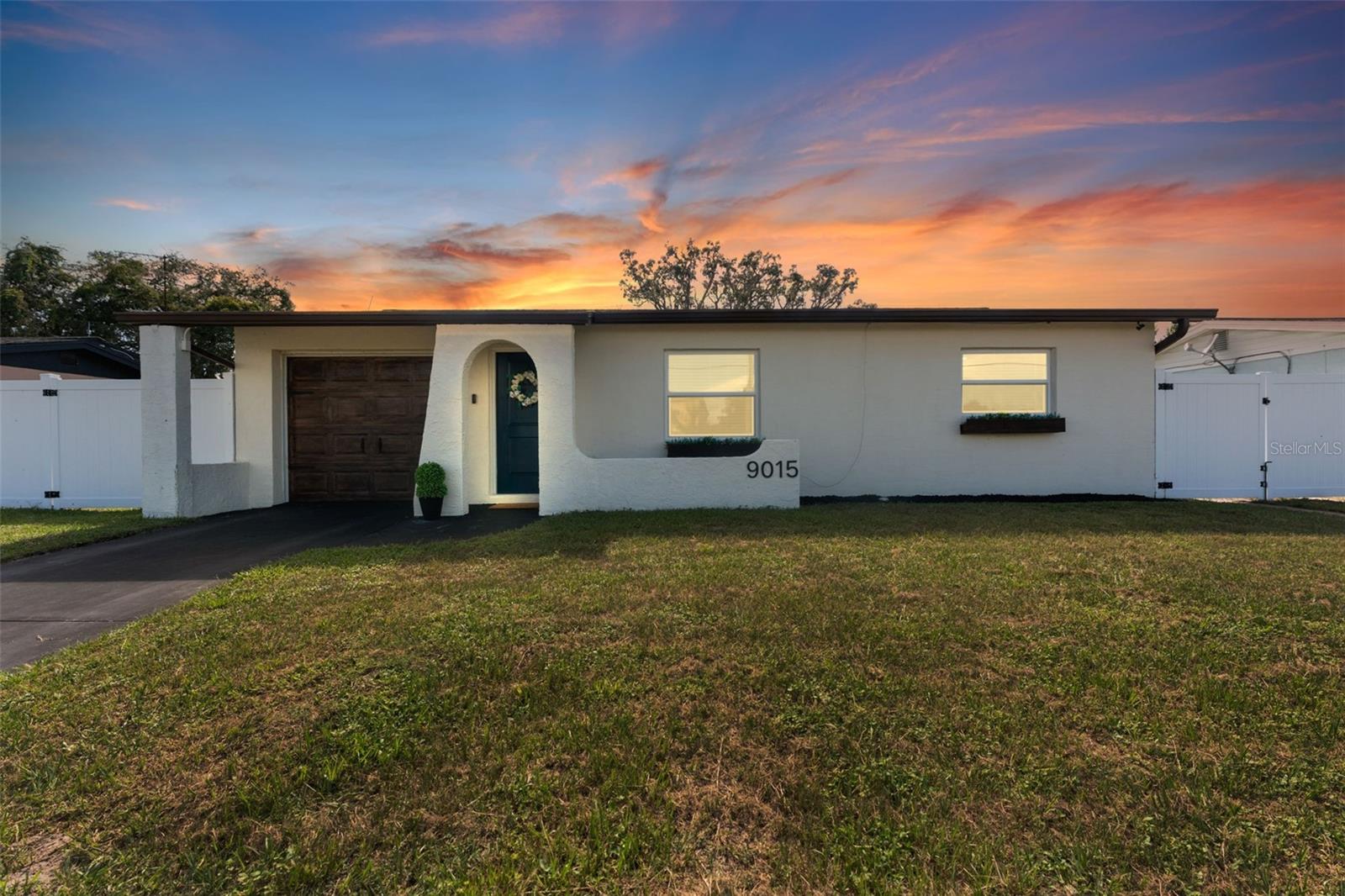 This beautifully remodeled 2-bedroom, 1-bath home with a 1-car garage offers comfort, style, and convenience. No Flood zone, no HOA, no CDD. ZERO damage from previous Hurricanes. Built in 1981, but completely updated within the last 4 years, it features an open floor plan, luxury vinyl flooring, and a remodeled kitchen with a spacious granite island and GE stainless steel appliances-including a fingerprint-resistant side-by-side refrigerator. Enjoy peace of mind with impact windows, a 14-SEER Heat Pump with new ducts, and a vinyl privacy fence with drive-through gates. The modern bathroom has luxurious tile and the bedrooms include custom built-in closets to maximize storage. Step outside to your large backyard with a patio, sparkling in-ground pool, and plenty of space to entertain including a car path big enough to park a boat or RV. Located in Port Richey, along the Gulf Coast, which is celebrated for its spectacular sunsets and abundant outdoor recreation convenient to restaurants, shopping, and even the water! Everything is fresh, modern, and designed for easy living just bring your suitcase!