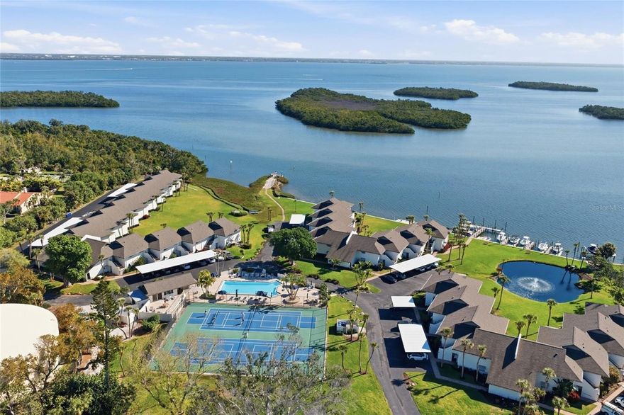 Waterfront Gem.  Refined coastal renovation, waterfront location, deeded beach, pet-friendly, pickleball, tennis, kayaking, boating, and the best of casual island living. Enjoy the larger D1 floorplan, offering owners more square footage in this open concept two-bedroom, two-bath condominium in Longboat Key's Pelican Harbour & Beach Club. Plus this unit comes totally turnkey furnished and is move-in ready.  The Association's amenities include private beach, tennis and pickleball courts, heated resort-style pool, clubhouse, bike storage, kayak launch, and owner boat docks. The condominium features include hurricane windows and doors, contemporary-style fireplace, new flooring, custom cabinetry, stainless appliances, crown molding, plantation shutters, tankless water heater, new air conditioner, and designer ceiling fans. Spacious primary suite boasts a private bath with custom walk-in shower, built-in closets, and water views. The guest suite, split from the primary, offers friends and family alike private space and a convenient adjoining bath with a custom walk-in shower, as well. There is plenty of closet space and storage throughout, and an in-unit laundry with matching front-load HE washer and dryer. In addition, with the D1 plan being larger than other Pelican Harbour two-bedroom condominiums, owners will appreciate the larger spaces for gathering and hosting.  Association provides on-site maintenance; landscaping; building property, wind, flood and liability insurances; roofs; exterior painting; cable; water; sewer; trash; and more. Pelican Harbour also has fully funded reserves and has installed new roofs, new hurricane-rated carports, upgraded pickleball and tennis courts, and offers owner boat docks with electric and water. Pelican's private beach is only steps away and offers stunning sunset and Gulf views with miles of turquoise waters and crystal sands. You'll also appreciate the convenient mid-island location close to Bayfront Park, grocery, restaurants, shopping, places of worship, and easy access to St. Armands, Sarasota and Anna Maria. Gorgeous coastal renovation, larger D1 floor plan, fantastic mid-island location, pet-friendly and one of the best amenity packages on the island. Enjoy Pelican Harbour and Beach Club.  Schedule your private showing.