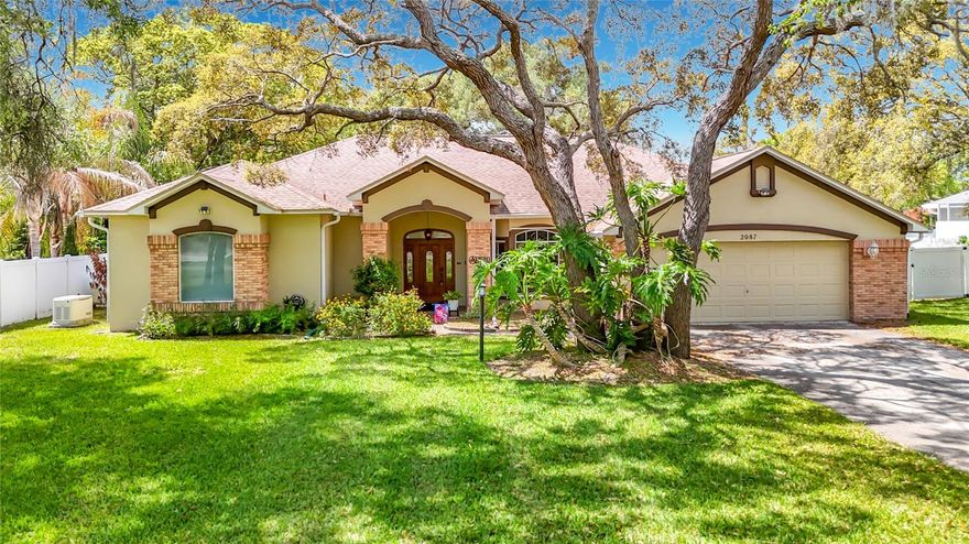 Don’t miss out on this rare find—a meticulously maintained spacious 3-bedroom, 2 bath solar heated pool home nestled on nearly ¾ acre in the heart of Spring Hill equipped with a whole house generator. As you arrive, you'll be welcomed by a charming brick-faced front entrance, mature oak trees, and an impressive front yard that sets a gracious tone. A stunning entry door opens to a beautifully tiled foyer and formal dining area, complete with soaring ceilings, a wine refrigerator, and bay windows adorned with plantation shutters. The living room boasts elegant trey ceilings and a faux fireplace that creates a warm, inviting ambiance. Indulge your culinary passions in the completely remodeled gourmet kitchen, featuring custom Brookwood cabinetry with soft-closed doors and pull-out drawers, striking granite countertops, stainless steel appliances including a Bosch double oven with convection upper, Bosch dishwasher and stylish plank tile flooring. The massive cooking island includes a sink, newer touchless faucet, and a Bosch induction cooktop with a modern exhaust hood, making it perfect for both everyday meals and entertaining. Enjoy relaxation or entertainment in the separate family room, which features brand new plank tile flooring, lovely tray ceilings, built-in glass shelves with mirrors, surround sound, pocket sliding doors, and contemporary sliding blinds. The room offers beautiful views of the pool and backyard, seamlessly connecting indoor and outdoor spaces. The generous master bedroom offers two large walk-in closets, one with custom shelving, and sliders that lead directly to the pool. The luxurious master bath features a decorative window with an electric blind, a jetted tub, a snail shower with a steam shower head, and updated tile work. The second bedroom includes laminate flooring, while the third bedroom has plank tile flooring and a bay window, both sharing access to the pool bath. A cozy office nook with plank tile flooring provides a perfect spot for work or study. The dedicated laundry room includes a washer and dryer, abundant cabinetry, and a utility sink for convenience. Step outside to the screen-enclosed lanai, where you can relax by the shimmering diamond brite pool and enjoy the serenity of a beautifully landscaped, fully fenced yard. This home is truly a blend of elegance, comfort, and functionality, ready to welcome you! Other amazing features include AC 2022, Roof 2021, windows/door replaced in 2013, new interior paint, hurricane shutters, dual hot water heater, newer pool pump with variable speed, newer filter and solar control, newer French drains, alarm system, whole house generator with propane 2021, Wi-Fi for sprinklers, nest thermostat, new LED lights with dimmer switches, front door entry and ring doorbell and camera. Oversized 2 car garage with Wi-Fi garage door opener, tons of storage, shed with electric and a window AC stays for that extra storage and sprinklers on well. This home is perfect for entertaining, so come envision your new beginning while it’s still available! NO HOA, NO CDD!! Close to the Suncoast parkway for quick access to the airport, Tampa, Clearwater and St. Pete Beaches (Ranked in the top 5 Beaches in the US), also close to the famous Tarpon Springs Sponge Docks. It is conveniently located close to restaurants, shopping, schools, and hospitals.