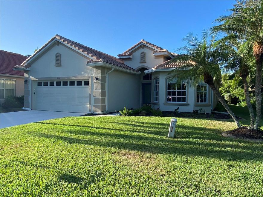 Tucked at the end of a quiet cul-de-sac in Heron Creek, 5351 Laurel Oak Ct is the kind of home that feels like a retreat. Surrounded by mature trees and lush natural foliage on three sides, it offers a level of privacy that’s hard to find in a gated golf community — peaceful mornings, shaded afternoons on the lanai, and the feeling of being “away,” even though everything you need is just minutes away.
Inside, the layout flows comfortably, with the living and dining room transitioning into the kitchen, dinette, and family room — ideal for everyday living and easy entertaining. The primary suite is privately situated with a spacious en-suite and walk-in shower, while the split bedroom plan provides comfort and flexibility for guests or home office needs. The home is vacant and ready for your personal touch, with major improvements already in place, including a newer roof (approximately 1.5 years old), tankless hot water heater, and a whole-house generator for added confidence during storm season. Transferable warranties remain with the home. The screened lanai extends along the rear of the home and looks out to mature trees rather than neighboring homes — a rare and desirable feature here. The setting is quiet and serene, yet just a short golf-cart ride to the clubhouse, fitness center, courts, pool, spa, dining options, and the 27-hole Arthur Hills-designed golf course. This cul-de-sac is also known, especially in season, for friendly gatherings and street socials — private, but not isolated. Additional highlights include no CDD, Zone X (no flood zone), fiber-optic internet and lawn irrigation included in the HOA, guard-gated entry, and convenient access to I-75 and next year the soon-to-open Sarasota Memorial Hospital–North Port medical campus. With its recent price adjustment, this home presents an opportunity to secure privacy, space, and peace of mind in one of North Port’s most established golf course communities — and tailor the interior to your personal style. *Interior photos are virtually staged*