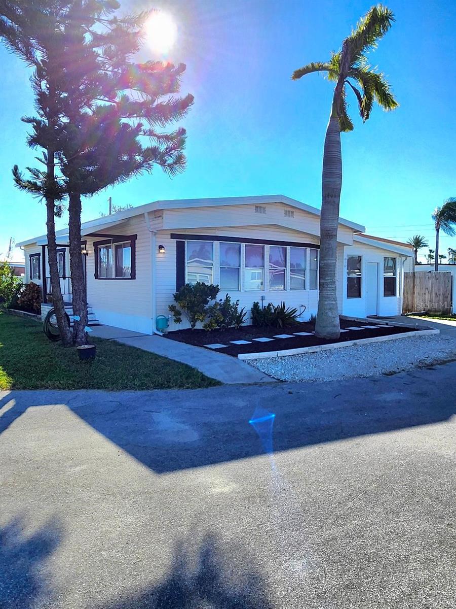 **ALL AGES** LAND OWNED and PET FRIENDLY! Over 1200 square feet of Living space in this 3 Bedroom, 2 Bath Manufactured Home on an oversized corner lot in the Floridana community. Spacious Living and Dining areas. Nicely updated Shaker style kitchen cabinets with custom dry bar. Roomy Master Bedroom fits a king size bed, has plenty of closets and an ensuite bath. Light and airy enclosed Florida Room to relax with a cup of coffee and a good book; OR a Bonus space with private entrance, great for Office, crafts, work out room, or a forth sleeping area for extra guests!...You decide. Huge inside Laundry room and lots of storage in this unit. Roof, 2015; A/C 2023. Completely fenced back yard with covered parking, and plenty of space for grilling and gathering of family and friends. An 8x12 detached shed completes this piece of Paradise. You own the land, no Lot rent. 20 minutes to Sarasota-Bradenton Int'l Airport. Convenient to shopping, restaurants, the Arts and everything in Bradenton/Sarasota. Bring all offers!