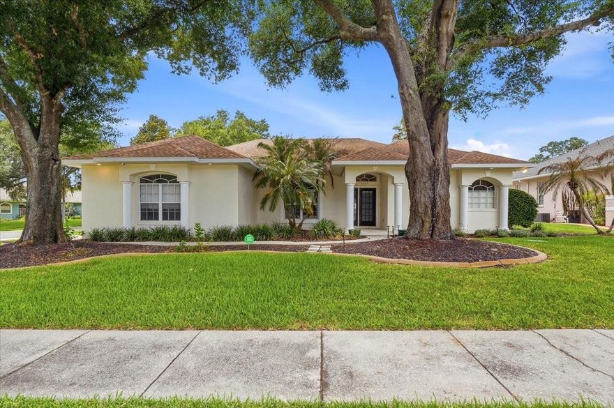Welcome home to Bloomfield Hills, one of Lakeland's most sought-after communities! Custom designed and built by renowned builder Ernie White, this Pool home offers timeless quality, spacious living, and a wonderful setting for both relaxation and entertaining.

Situated on a beautifully landscaped corner lot with mature trees and a desirable side-entry garage, this 3-bedroom, 2-bath home also features a dedicated office complete with a glass entry door and built-in shelving. Inside, you'll find soaring 10-foot ceilings, recessed lighting, durable luxury vinyl plank flooring throughout most of the home, and an abundance of natural light.

Designed with entertaining in mind, three 9-foot sliding glass doors open seamlessly to the screened pool area, creating the perfect indoor-outdoor lifestyle. The spacious dining room overlooks both the formal living area and family room, while the kitchen features stainless steel appliances and a convenient pass-through window to the covered poolside bar seating area.

The generously sized primary suite offers a private retreat with dual walk-in closets, a large ensuite bath featuring dual vanities, a garden tub, oversized shower, private water closet, and dedicated makeup vanity space.

Step outside to enjoy your private sports pool with a full screen enclosure, aluminum safety gate, and multiple access points, including a convenient doggie door. The fenced backyard provides plenty of room for pets, play, or gardening, with both single and double gate access. Additional updates include a new drainfield installed in 2024 for added peace of mind.

Residents of Bloomfield Hills also enjoy access to community tennis courts. With its exceptional layout, custom details, and beautiful outdoor living spaces, this home offers the perfect blend of comfort, functionality, and Florida living. Don't miss your opportunity to make it yours!