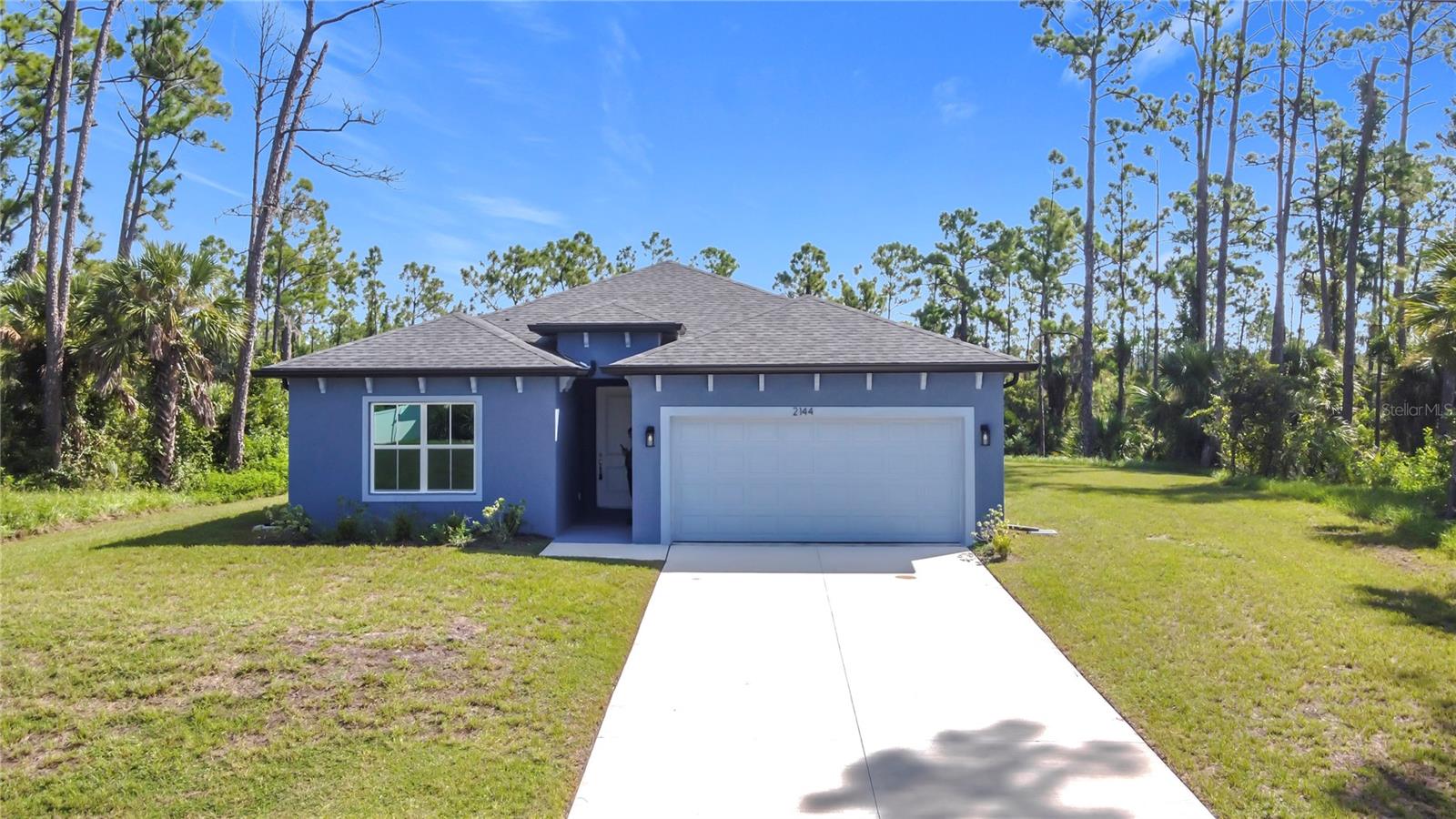 NEW CONSTRUCTION - Completed, move-in ready! This concrete block 4-bedroom 3-bathroom 2 car garage home has 80 ft canal frontage and is not in a Flood Zone. This home boast a modern design with high ceilings and features an open spacious floorplan design. With an awesome gourmet-inspired kitchen that features white cabinets with a large center island and subway backsplash and upgrades that include Stainless-steel Samsung appliance package with washer and dryer. Luxury wood-vinyl flooring throughout the common areas. A spacious master bedroom with tray ceilings, two walk-in closets, a private bathroom with dual vanity area, and large open walk-in shower. Front bedroom with bathroom is perfect for a guest room, mother in-law suite, or office. Home also features indoor laundry room connecting the attached garage, water softener, double pane windows, and sliding glassdoor that lead out to the open lanai. This brand new home is a must see.