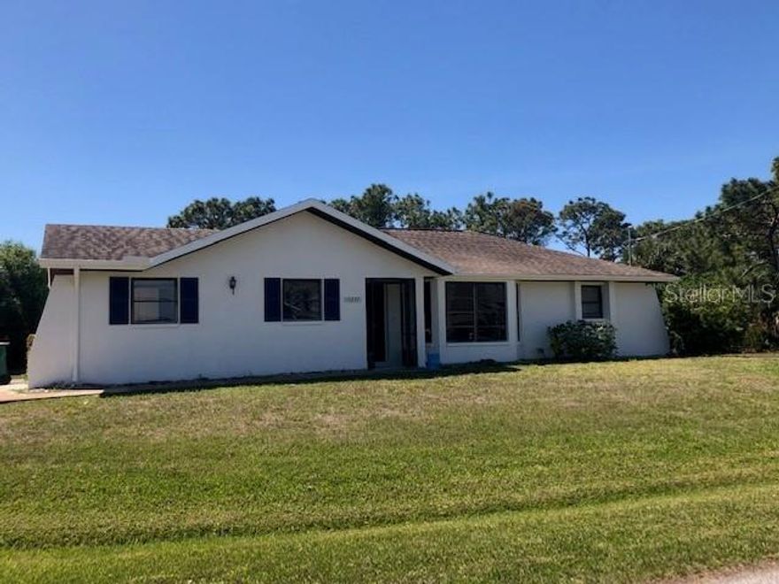 Situated on close to half an acre this cute starter home/income producer includes the adjacent lot. Being sold "As Is" and needs a little bit of work after the hurricane but is in very livable move in condition. Prior to the storm the home was newly painted inside and out and has new vinyl plank flooring throughout. Ac was replaced in 2019 and new garage door was replaced in 2023.Spacious open plan living/family/dining area and bedrooms are on opposite sides of the house with their own bathrooms. Large screened in lanai off the family room with ample room for table chairs and seating area. Minutes to shopping, local restaurants and short drive to Englewood Beach and Boca Grande.