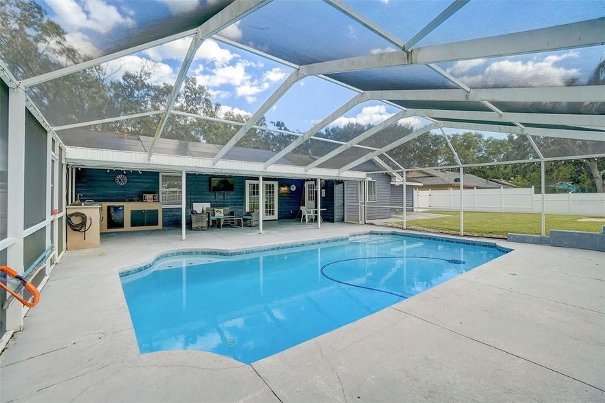 Welcome to your dream home in the desirable Imperial Lakes community! This newly listed 3-bedroom, 2-bathroom lakefront pool home is a true gem. This property is in high demand, so we're seeking the highest and best offer.

From the moment you step up to the front door, you'll be captivated by the charm and appeal of this move-in-ready residence. The sellers have poured their hearts into enhancing every corner of this lovely abode, paying meticulous attention to detail.

As you enter, you'll be greeted by a split floor plan that optimizes space and functionality. The central great room boasts soaring vaulted ceilings and seamlessly connects to the adjacent dining area and open kitchen. This layout makes it easy to entertain and enjoy the company of family and friends.

Natural light bathes every room in the house, thanks to the large windows that frame the beautiful outdoor surroundings. The kitchen, a true highlight of this home, features wood cabinets, ample counter space, a convenient closet pantry, modern appliances, and a French door that opens to the patio, offering a breathtaking view of the lake.

The primary suite is a cozy retreat with a walk-in closet complete with built-in storage and a tastefully remodeled private ensuite bathroom. Whether you're enjoying your morning coffee on the patio or a quiet evening indoors, you'll relish the serene ambiance this home provides.

Step outside, and you'll find your own private oasis. The pool is perfect for cooling off on those warm Florida days, and the covered patio with an expansive outdoor kitchen area is an ideal spot for relaxing, grilling, or hosting gatherings. The fully fenced backyard also boasts a charming firepit area, adding to the appeal of outdoor living.

This home has seen numerous recent improvements to ensure your comfort and peace of mind, including a new AC system from 2020, beautifully remodeled bathrooms, fresh interior and exterior paint, a refinished pool surface, and new screening on the pool cage. Over the last few years, there have also been updates to the flooring, fencing, driveway, and roof shingles installed in 2017. The result is a pristine and well-maintained property, ready for its new owners.

This home offers not only a charming and well-maintained living space but also impressive energy efficiency. With its new panels, it's quite a surprise that the electric bill averages less than $40 a month with TECO. This remarkable energy efficiency is a testament to the upgrades and attention to detail that have been put into this property. It not only ensures that you'll enjoy a comfortable and cozy living environment but also allows you to save on your monthly utility costs. Imagine the peace of mind and extra savings that come with such an energy-efficient home, making it an even more attractive and practical choice for prospective buyers.

Don't miss this opportunity to make this exquisite lakefront pool home in Imperial Lakes yours. Priced competitively and meticulously cared for, it's sure to sell quickly. Reach out today and schedule a showing to experience the serenity and charm of this wonderful residence for yourself.