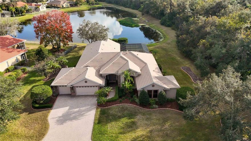 Timeless with a relaxed, understated elegance, this rare Deerwalk offering in Greyhawk Landing presents an oversized lot approaching half an acre view of water and nature preserve with no rear neighbors a level of privacy seldom available. Designed for those who value space, flexibility, and serenity, the home balances refined architecture with a calming, nature-inspired interior that feels both elevated and effortless. Light-filled living areas framed by expansive glass create a constant connection to the outdoors, where tranquil views set the tone for everyday living. The thoughtfully designed layout includes four bedrooms, three bathrooms, and a versatile bonus room ideal for multigenerational living, long-term guests, or a private work-from-home retreat. A secluded fourth-bedroom suite with custom Murphy bed, sitting area, office space, closet, and private bath access offers true independence perfect in-law suite, guests wing. The great room, anchored by a gas fireplace, opens through triple pocket sliders to a resort-style outdoor living space. A gas-heated saltwater pool and spa with a dramatic double rock waterfall overlook preserved natural views, pre plumbed and wired for an outdoor kitchen, creating a setting equally suited for intimate evenings or refined entertainment. Custom lighting, tropical landscaping, and frequent wildlife sightings enhance the sense of privacy and calm, while custom blinds maintain soft natural light throughout the home. Architectural details and curated finishes elevate the experience, including double tray ceilings, crown molding, vaulted ceilings, hardwood flooring, porcelain tile, granite countertops, custom closets, and a spa-inspired owner’s suite with dual vanities and a garden soaking tub. Original meticulous owners built this custom Cortez model home. Greyhawk Landing is an established, gated community prized for its mature landscaping, scenic lakes, and extensive amenities, including two clubhouses, resort-style pools, fitness center, pickleball and tennis courts, walking and biking trails, and recreational fields—all centrally located near Lakewood Ranch, Sarasota, and Florida’s Gulf Coast beaches. Opportunities offering this level of privacy, flexibility, and natural beauty are increasingly rare. Designed to slow life down and elevate daily living, this home invites you to experience a more intentional Florida lifestyle, schedule your private showing today.