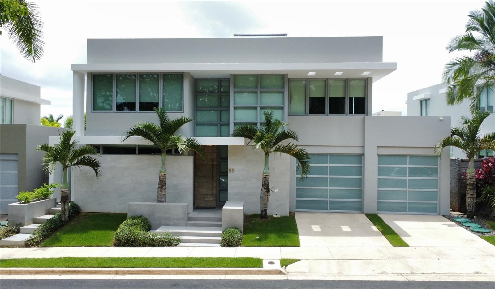 For rent in the exclusive community of Senderos de Montehiedra / Montehiedra West: a stunning 4-bedroom, 3.5-bathroom home offering 3,700 ft² of modern, functional living space on a 488.93 m² lot. This elegant residence features a luxurious primary suite with a custom California Closets walk-in closet (with its own A/C) and private terrace, a versatile flex room perfect for a gym or office, and a fully equipped kitchen with high-end appliances including a refrigerator, stove, microwave, dishwasher, freezer, garbage disposal, and two wine/beverage coolers. The home is fully air-conditioned, with a central inverter A/C on the main floor and individual units in all bedrooms and key areas. Outside, enjoy a saltwater pool with heating system, firepit, built-in BBQ bar, beverage center, ice maker, and a green wall for a modern touch. The property includes a 30 kW diesel generator, 34 solar panels with 40.8 kWh battery backup, solar water heater, and two 600-gallon cisterns. Located in a gated community with double access control, residents also enjoy access to two activity centers, a gym, swimming pools, tennis, basketball, and volleyball courts, and a children's playground. This home is the perfect blend of luxury, comfort, and sustainability—ready to become your next home.