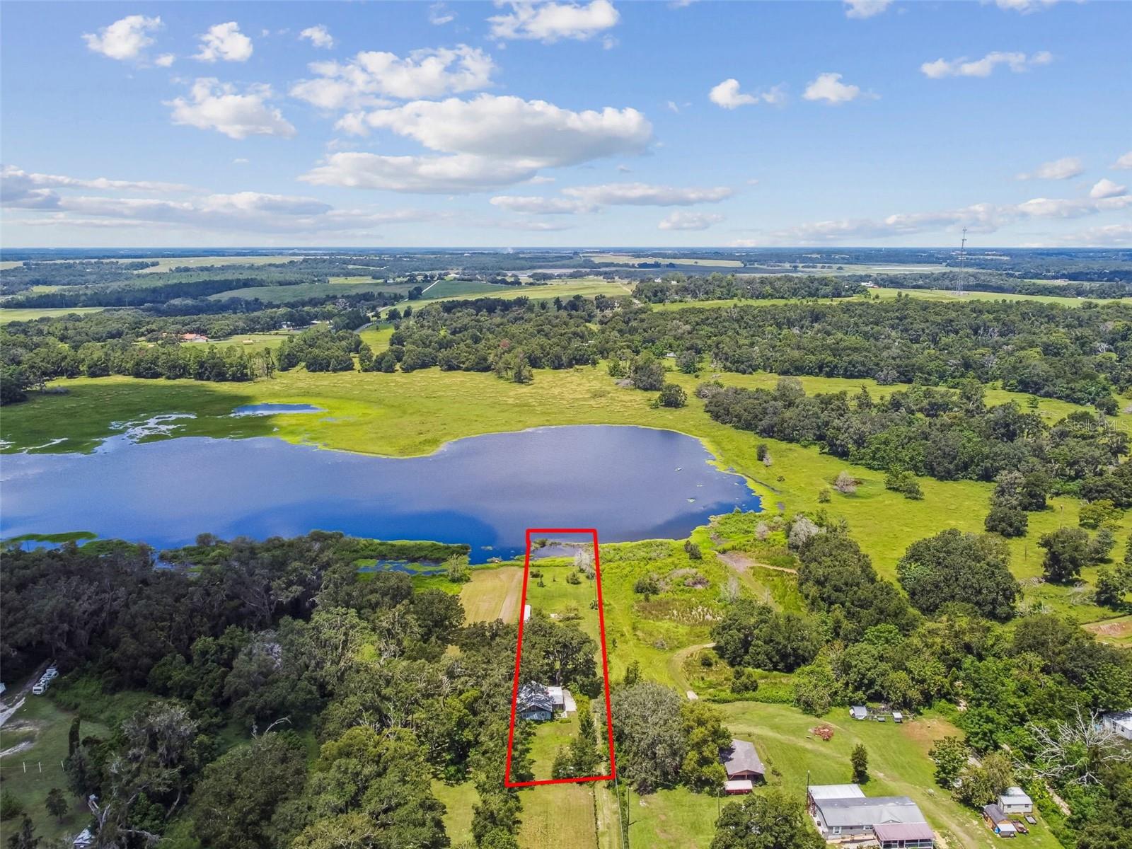 WELCOME TO LAKEFRONT PARADISE! This 1.4 acre LAKEFRONT property offers the privacy, views, and tranquil setting you have been dreaming of. Convenient yet secluded, this property is located off US301 between Zephyrhills and Dade City providing quick access to SR52 and I-75. Property currently includes a single family block construction home that requires extensive repairs - a perfect canvas to add your touch, or build a brand new home overlooking the serene lake. Opportunities like this don’t come often—this is the only lakefront property under $200K in Pasco County! A recent survey is available, making your planning even easier. Don’t miss your chance to own this affordable piece of lakefront paradise!