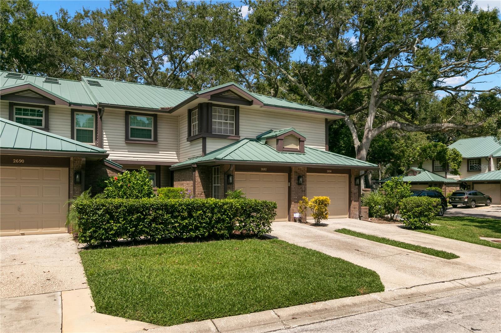 Welcome to 2692 Walnut Dr in Palm Harbor and located in the much desired community of Laural Oaks! This ground floor unit with 2 bedrooms, 2 full baths, one car garage and guest parking just steps from your unit. Pet friendly where you can have 2 pets. Just minutes from the renowned Fred Marquis Pinellas Trail and the award-winning Honeymoon Island State Park! The Pinellas Trail spans nearly 40 miles, offering scenic biking, walking, and jogging paths that connect charming downtowns like Dunedin, Clearwater, and Tarpon Springs. Honeymoon Island, one of Florida’s most celebrated beach parks, features pristine white-sand beaches, nature trails, and ferry access to Caladesi Island. Living here means endless opportunities for recreation, relaxation, and soaking up the best of the Florida coastal lifestyle—just mins from your doorstep. Step inside this inviting living space featuring easy-care flooring, crown molding, and a cozy fireplace that adds warmth and character. The family room flows effortlessly to the enlosed porch area ideal for relaxing or enjoying morning coffee while overlooking the private backyard with lush greenery and mature trees. The well-designed kitchen offers ample cabinet space, stainless steel appliances, and a convenient layout that makes cooking a breeze. Both bedrooms are generously sized, with the primary suite with sliders out to the private porch area and offering a private en-suite bath and plenty of closet space with built ins. A second full bath has been updated and provides a tub/shower combo and convenience for family or guests. One car garage and full size washer and dryer hook ups add to the convenience of this floorplan. Enjoy resort-style amenities mins from your door, including a community pool with lounging area, perfect for cooling off on sunny Florida days, hot tub and tennis courts. With low-maintenance living, a prime location close to shopping, dining, and beaches, and direct access to some of the area’s best outdoor recreation, this home truly has it all. Don’t miss this opportunity to own a ground-floor condo with garage in one of Palm Harbors most desirable spots! Call today for your private tour.
