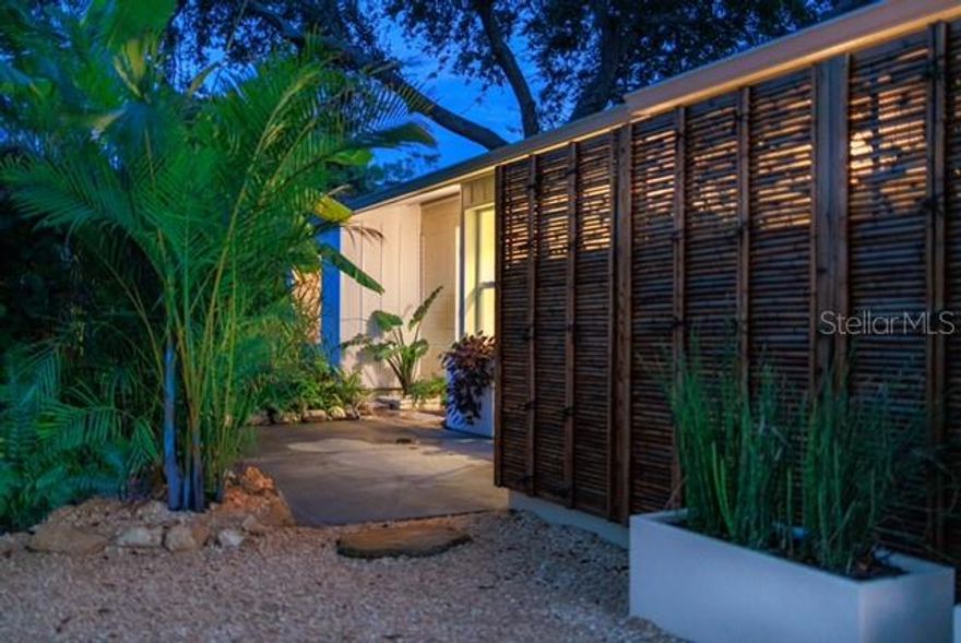 Architect-Designed Masterpiece of Indoor – Outdoor Living……….

this meticulously crafted residence sits on a prime Sarasota lot of nearly 10,000 sq ft. The design embodies a Garden – Architecture Integrated Layout; A concept known as The MODERN - BOHEMIAN  style and is devoted to creating meaningful interactions between the built environment and the surrounding landscape…… by fusing the warmth, nature, and free spirit of Bohemian (Boho) with the simplicity, sophistication, and functionalism of Modern (Modern) style. It is a blended aesthetic that seeks a relaxed, personalized atmosphere while maintaining visual neatness and a sense of refinement.

The entire property is poetically expressed as “One Dwelling, One Pavilion, Three Courtyards,” consisting of the main residence (Dwelling), the detached multifunctional studio (Pavilion), and the Front, Back, and Side Yards that encircle both structures…… The main residence deliberately minimizes hallways and maximizes usable space. This efficiency, combined with practical bathroom sizing and the presence of four custom viewing niches throughout the home, significantly improves the overall usage efficiency of the floor plan. 

• Design Philosophy: Courtyard Suites Immersed in Nature……….
The main house and gardens form a cohesive ecosystem, where every interior space extends seamlessly toward the outdoors…..
• Living & Dining….
    The living room opens fully to the side yard through folding sliding window doors, transforming it into an outdoor extension ideal for gatherings…..
 The open kitchen, island, and dining area flow into a dramatic 9’ × 32’’ panoramic bay window, offering tranquil views of mature trees in the front garden—dining here feels like sitting within a private forest…..
• Bedrooms…..
    • Primary Suite: Floor-to-ceiling sliding window doors frame the expansive rear garden, creating a private retreat with a luxurious landscape backdrop…..
    • Bedrooms 2 & 3: Bay windows paired with built-in seating nooks bring the garden inward, allowing each room to feel gently embraced by nature…..
    • Bedroom 4 / Study: Designed as a home office and reading room, this space is surrounded by both side and rear gardens. Two large windows plus a sliding door allows one to view the garden from different angles…..
Every room becomes a private courtyard suite, each offering its own intimate connection with the surrounding gardens…..
The Pavilion: Multifunctional Studio & Outdoor Activity Hub…..
Detached from the main residence, the 240 sq ft Shed serves as a highly versatile bonus structure. Featuring electric service, water, sewer, AC, cable connection, insulation, and garden views, it functions perfectly as a Mini Office, workshop, media room, or creative studio, including an integrated laundry area with new washer and dryer that conveys with the property…..
Directly outside the shed window lies a dedicated outdoor BBQ zone, making this pavilion the center of outdoor living. The design reinterprets traditional “garage culture” into an elevated, modern backyard lifestyle hub. .....See pictures for additional information on each room.