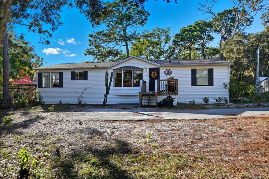 4 acre property in Highlands Subdivision in Hudson with an updated, 3 Bedroom, 2 Bathroom well-maintained manufactured home. Bring your farm animals and enjoy this non flood zoned usable 4 acres. As you enter through the gated entrance and drive up the long newer driveway to the stunning country setting you will impressed with the peace and quiet this property offers. The living room is adorned with a woodburning fireplace to take the chill off during our cooler winter days/nights and adds to the country charm of this home. Kitchen is large with updated cabinets. Primary bedroom is split from the two secondary bedrooms offering privacy. New Barndoors from the primary bedroom to the primary ensuite bathroom. ZONED AC AGRICULTURAL. NO HOA! NO CDD! ROOF 3 YEARS NEW. WELL HAS A 3 YEAR NEW WELL PUMP. SEPTIC- NEWER DRAIN FEILD IN THE LAST 8 YEARS. HVAC 2018. BOTH SHEDS STAY.  Fully fenced property. This home is close proximity to 19 and county line, shopping, restaurants, medical. The pool, trampoline, and swing set will be removed prior to close.