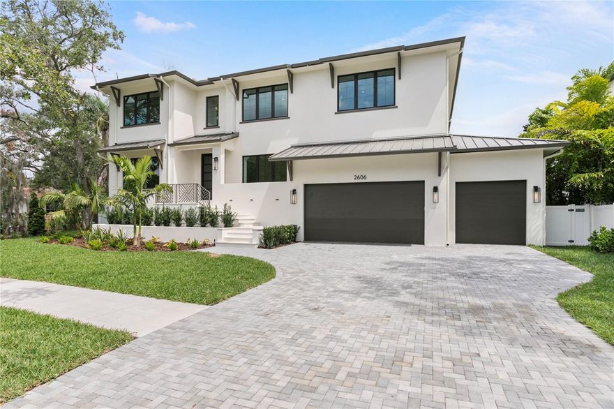 Under Construction. WILL BE COMPLETED BY 9/30/2025! Located in the prestigious Sunset Park neighborhood of South Tampa, this luxury residence is a masterclass in architectural integrity, designer finishes, and state-of-the-art construction.  Built to withstand the elements with first and second floor solid block construction, steel-reinforced stem walls and PGT rated impact windows, this home has been engineered to exceed 150 MPH wind load standards offering exceptional structural integrity and peace of mind. A full-home generator, vapor-sealed concrete foundation, and Icynene foam insulation ensure year-round comfort and uninterrupted performance in any condition. Across every inch of this residence, the attention to detail is undeniable. The professionally designed exterior features a paver driveway, slick stucco finish, 30-year dimensional shingle roof, bronze gutters, and a marble-clad front porch. Inside, 10ft to 10ft 8in ceilings, 7.25in baseboards, oak tread staircase, level 5 drywall finishes, and single-panel 8ft solid core doors create an atmosphere of timeless elegance. Engineered hardwood floors run throughout the living spaces, complemented by coffered ceilings. The open-concept floor plan is anchored by a stunning designer kitchen with full custom cabinetry, level 6 quartz counters, full-height quartz backsplash, pot filler, and professional Thermador appliance package including 30” refrigerator and freezer towers, 36” cooktop, double ovens, microwave drawer, and a vented hood. A walk-in butler’s pantry adds function and style with LED-lit white oak floating shelves and dual 24” beverage/wine fridges. Indoor-outdoor living is effortless with a 16’ impact-rated sliding glass door that opens to a marble-clad lanai, complete with an outdoor kitchen that includes marine-grade cabinetry, a 32” Artisan gas grill, beverage fridge, stainless sink & 3 outdoor speakers. The outdoor space is complete with a resort-style pool with spa and sun shelf, perfect for year-round entertaining. A hydraulic elevator offers easy access to the second floor, where you’ll find the expansive primary suite featuring soaring ceilings, a private beverage center, and a spa-caliber en suite bath with dual vanities, designer marble, a soaking garden tub, large walk-in shower, and custom built-in closet system. Each secondary bedroom on this floor also includes a walk-in closet with built-in closet systems and en suite bath, designed with thoughtful finishes and insulation for sound control. A second-floor loft, laundry room, media room, and dedicated AV closet expand the home’s functionality and flexibility. Additional highlights include two Navien tankless gas water heaters, 2 17+ SEER Carrier HVAC systems with 2 programmable Ecobee smart thermostats, Gyp-Crete for fire and sound resistance, and in-wall pest control tubes. The oversized 4-car garage (2-car tandem) features high-lift doors, 16’6” ceilings, and WiFi-enabled openers. This home blends state-of-the-art features with fresh modern elegance. Situated within the Plant High School district and minutes from Tampa’s top dining, shopping, and commuter routes, this is more than a home, it’s an investment in exceptional living.