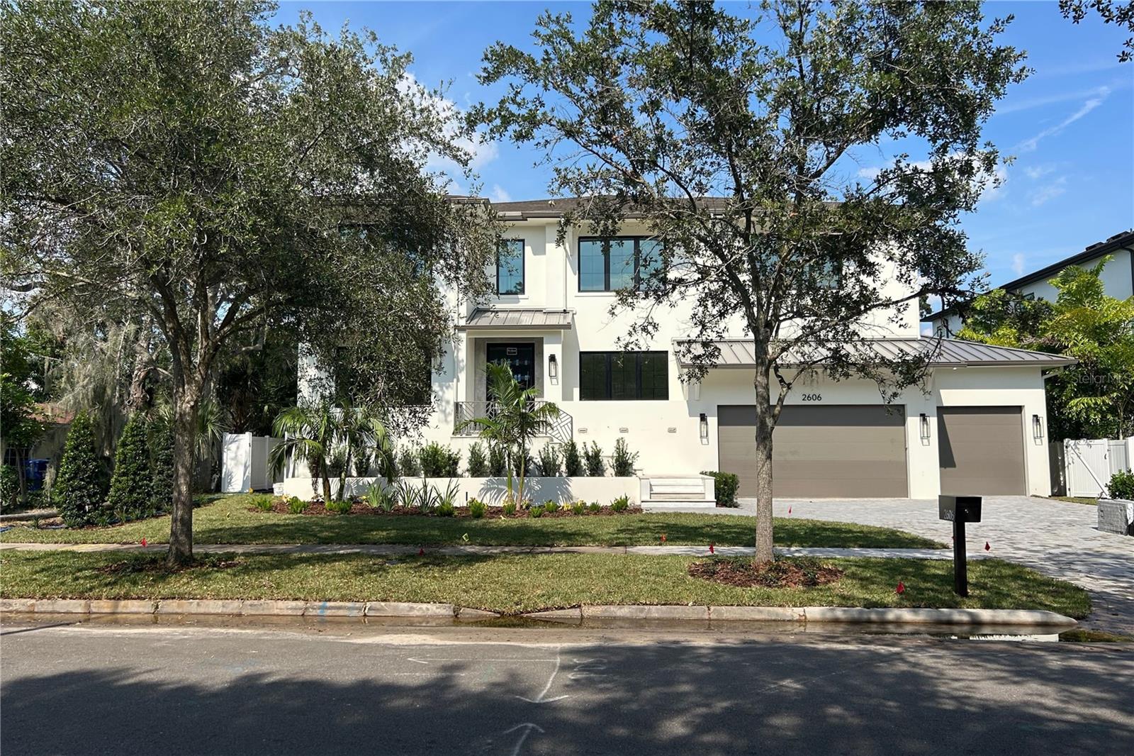 Under Construction. WILL BE COMPLETED BY 9/30/2025! Located in the prestigious Sunset Park neighborhood of South Tampa, this luxury residence is a masterclass in architectural integrity, designer finishes, and state-of-the-art construction. Built to withstand the elements with first and second floor solid block construction, steel-reinforced stem walls and PGT rated impact windows, this home has been engineered to exceed 150 MPH wind load standards offering exceptional structural integrity and peace of mind. A full-home generator, vapor-sealed concrete foundation, and Icynene foam insulation ensure year-round comfort and uninterrupted performance in any condition. Across every inch of this residence, the attention to detail is undeniable. The professionally designed exterior features a paver driveway, slick stucco finish, 30-year dimensional shingle roof, bronze gutters, and a marble-clad front porch. Inside, 10ft to 10ft 8in ceilings, 7.25in baseboards, oak tread staircase, level 5 drywall finishes, and single-panel 8ft solid core doors create an atmosphere of timeless elegance. Engineered hardwood floors run throughout the living spaces, complemented by coffered ceilings. The open-concept floor plan is anchored by a stunning designer kitchen with full custom cabinetry, level 6 quartz counters, full-height quartz backsplash, pot filler, and professional Thermador appliance package including 30” refrigerator and freezer towers, 36” cooktop, double ovens, microwave drawer, and a vented hood. A walk-in butler’s pantry adds function and style with LED-lit white oak floating shelves and dual 24” beverage/wine fridges. Indoor-outdoor living is effortless with a 16’ impact-rated sliding glass door that opens to a marble-clad lanai, complete with an outdoor kitchen that includes marine-grade cabinetry, a 32” Artisan gas grill, beverage fridge, stainless sink & 3 outdoor speakers. The outdoor space is complete with a resort-style pool with spa and sun shelf, perfect for year-round entertaining. A hydraulic elevator offers easy access to the second floor, where you’ll find the expansive primary suite featuring soaring ceilings, a private beverage center, and a spa-caliber en suite bath with dual vanities, designer marble, a soaking garden tub, large walk-in shower, and custom built-in closet system. Each secondary bedroom on this floor also includes a walk-in closet with built-in closet systems and en suite bath, designed with thoughtful finishes and insulation for sound control. A second-floor loft, laundry room, media room, and dedicated AV closet expand the home’s functionality and flexibility. Additional highlights include two Navien tankless gas water heaters, 2 17+ SEER Carrier HVAC systems with 2 programmable Ecobee smart thermostats, Gyp-Crete for fire and sound resistance, and in-wall pest control tubes. The oversized 4-car garage (2-car tandem) features high-lift doors, 16’6” ceilings, and WiFi-enabled openers. This home blends state-of-the-art features with fresh modern elegance. Situated within the Plant High School district and minutes from Tampa’s top dining, shopping, and commuter routes, this is more than a home, it’s an investment in exceptional living.