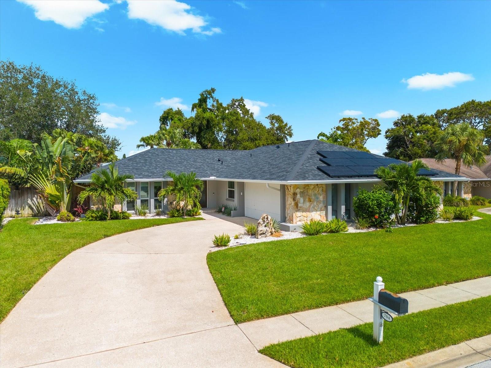 Welcome to The Bluffs conveniently located close to Belleair Bluffs shopping, dining and white sandy beaches. Upon arrival you will notice the perfectly manicured landscape and freshly painted exterior. The double door entry invites you into this great floorplan offering multiple living spaces and a split bedroom layout with an option for dual co-primary suites. French doors take you into your completely transformed backyard oasis that rivals any resort. This meticulously reimagined outdoor sanctuary features a stunning new heated and chilled pool and spa, where seven fiber optic lights create mesmerizing underwater constellations that dance beneath Florida's evening sky while lush landscaping frames your private sanctuary with tropical elegance. Every summer evening becomes an event, every gathering unforgettable. Your Hurricane Haven extends far beyond beauty—it's engineered for complete energy independence. Advanced solar panels crown this high-and-dry hideaway, while dual Tesla Powerwalls ensure uninterrupted power when storms threaten. Hurricane protection systems stand ready, making this your secure refuge where others evacuate. Updates include roof, AC, impact windows, solar system and more. This thoughtfully upgraded home will be worry-free for years to come while you contemplate spending your days poolside or exploring nearby Belleair Boat Docks and the pristine white sandy beaches of Indian Rocks Beach and Belleair Beach.