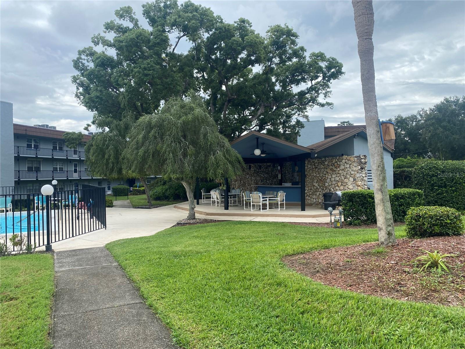 A 55+ Active community well maintained surrounded by gorgeous landscaping, dock access to the Winter Haven's Chain of Lakes (LAKE HOWARD). This second floor unit offers a range of amenities that includes a recreational room, heated community pool, shuffleboard, and grills to BBQ by the beautiful gazebo, community boat ramp nearby fishing allowed. Check out this 2 bedroom, 2 bath condo with an enclosed bonus room, this home offers a SPACIOOUS open concept living/dining room combo and a kitchen with plenty of cabinets and closet space throughout the unit for added convenience. Large master bedroom featuring its own bathroom and walk-in-closed. Newer windows for energy efficiency. Elevator located in the building for convenience. Covered assigned parking space just for you and plenty of guest parking. HOA covers Cable, Internet, Water, Sewer and Trash. Convenient to restaurants, shopping and medical care.