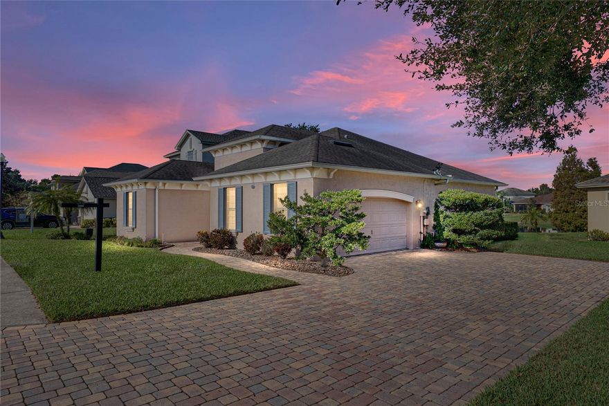 **A NEW ROOF WILL BE INSTALLED PRIOR TO CLOSING** Welcome to an elegant and inviting retreat in the sought-after Morgan Creek community of Lakeland, where thoughtful design, timeless finishes, and serene surroundings come together to create a place that truly feels like home. From the moment you arrive, the paver driveway, matching walkway, and charming front porch set a warm and welcoming tone, offering beautiful curb appeal and a hint of the comfort that awaits inside.  Step through the front door into an open-concept floorplan designed for both everyday living and effortless entertaining. The kitchen, dining area, and living room flow seamlessly together, creating a central gathering space that feels open yet intimate. Wood floors throughout the main living areas add warmth and sophistication, while tray ceilings and crown molding elevate the space with architectural detail and timeless appeal.  The living room is both stylish and functional, featuring custom built-in cabinetry that creates a dedicated entertainment area and sliding glass doors that invite natural light and provide direct access to the lanai. This indoor-outdoor connection makes it easy to enjoy Florida living year-round, whether you’re hosting guests or simply relaxing at the end of the day.  At the heart of the home, the kitchen is designed to impress. Corian countertops, a striking mosaic tile backsplash, and a spacious island provide both beauty and functionality. A two-tiered breakfast bar offers additional seating, perfect for casual meals or morning coffee, while the built-in pantry ensures ample storage and organization. The adjacent dining area completes this inviting space, ideal for everything from intimate dinners to festive gatherings.  The primary suite is a true sanctuary, thoughtfully positioned to capture tranquil water views. This generous retreat includes a comfortable seating area, a spacious walk-in closet, and a well-appointed en suite bathroom. Under-cabinet lighting adds a soft, ambient glow, while the garden tub and glass-enclosed shower create a spa-like atmosphere designed for relaxation and renewal.  Two additional bedrooms are equally well planned, each featuring dual closets and soft carpeting for comfort. These rooms share a conveniently located guest bathroom, making them ideal for family members, guests, or a home office setup.  With tile flooring in the kitchen and bathrooms, plush carpet in the bedrooms, and quality finishes throughout, this home offers both beauty and practicality. Located in a peaceful, well-maintained community with easy access to shopping, dining, medical facilities, and major roadways, this Morgan Creek residence offers the perfect balance of privacy, convenience, and refined Florida living.  This is more than a home—it’s a place to settle in, entertain with ease, and enjoy the everyday moments that make life truly special.