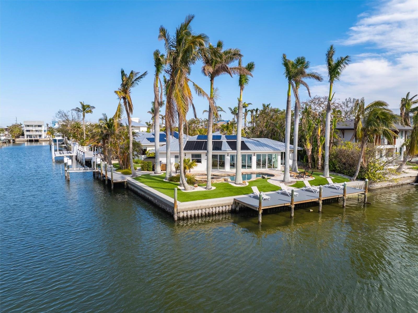 Welcome to Mintfish, your calm, canal front oasis. This home marries natural elements with luxury to create the perfect home for you or a fantastic investment vacation rental. The ground-level, single-floor home makes relaxation accessible for anyone and everyone. Completely remediated and remodeled has brought this 4 bedroom, 4 bathroom home back to its pristine condition. The calming colors and organic vibe will make you never want to leave. The open floor concept is very spacious with a huge living and dining area to enjoy the view out of the full wall of slider doors. The bedrooms are all spread out perfectly in all corners of the home for the utmost comfort and privacy for everyone. Nestled at the end of a quiet cul-de-sac on the north end of Anna Maria Island, Mintfish provides close proximity to Gulf beaches, beautiful sights, and perfect weather. Take in the stunning views of the open wide canal, soak and relax in your own private, heated pool. Fish off the dock or hop on kayaks or paddle boards for a nature stroll to see dolphins and manatees frolicing in the canal. Boaters still have a boat lift on the side canal so your boat doesn’t block your front panoramic canal views. Enjoy entertaining outside and cook on the outdoor gas grill for a delicious outdoor dinner. Very close to Pine Ave to enjoy all the restaurants and boutiques, this unique type of property doesn't come available often, schedule your showing today!!