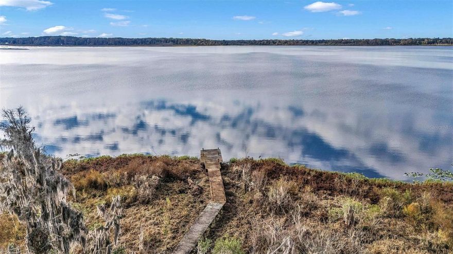 The property is located on the pristine 576 acre Little Orange Lake providing fishing boating, kayaking/canoeing, and other water based activities.  The uplands portion consists of 1.1 acres.  The property has a 750 foot boardwalk stretching from the uplands all the way to Little Orange Lake.   The boardwalk was constructed in the early 2000's and is in fair condition.   However, it is in need of some repair to ensure its safety.  Therefore, the boardwalk is included in the sale in an "As Is Condition" and the structural integrity and safety is NOT GUARANTEED by the seller.  

The property is rural and heavily wooded yet located less than 30 minutes to Gainesville's shopping and amenities.   The property is 45 minutes to the St. John's River and 1.5 hours to the Atlantic Ocean.