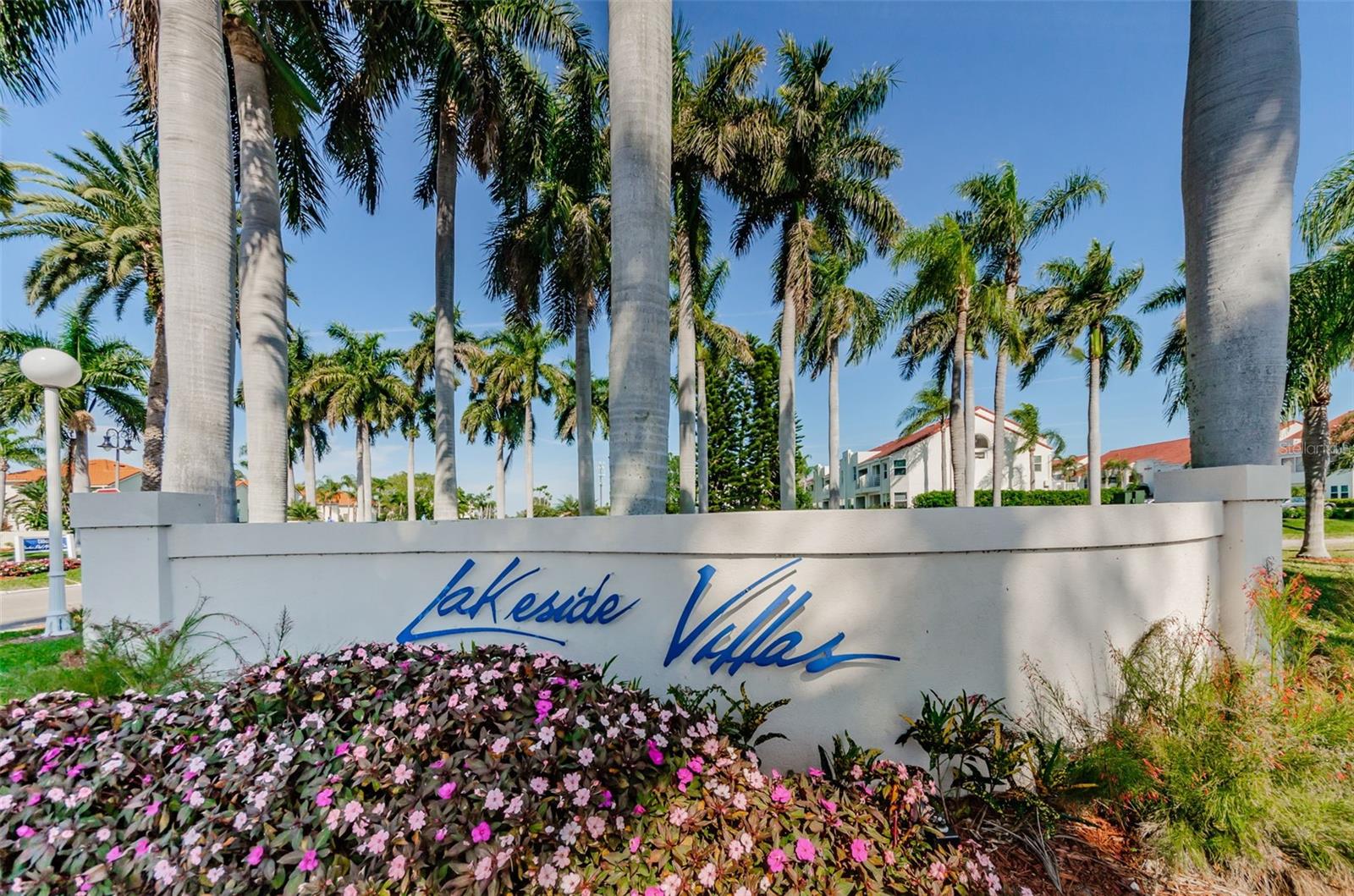 Find paradise in this one-of-a-kind lakefront villa in beautiful Bahia Vista. This corner unit feels quite private compared to other units and also features a deck that’s larger than usual. Step in onto lavish ceramic tile that encompasses the kitchen and living room. The updated kitchen contains stainless steel appliances, a vibrant backsplash, and unique pendant lights that hang over the breakfast bar. Walking into the living room, you’ll find a large space to entertain guests and relax. The primary bedroom has wood-look laminate flooring, a gorgeous ensuite bathroom and walk-in closet. From this bedroom, you can access the spacious deck, and lounge by the water. This deck also features a small storage shed for tools or outdoor equipment. Heading back inside, the ensuite bathroom that connects to the primary bedroom has a step-in shower with beautiful tiling and a large vanity. The walk-in closet features a convenient organization system for easy clothing storage. The secondary bedroom also has laminate flooring with a wood-look, this room allows for plenty of natural light to come through. The secondary bathroom features a beautiful shower tile design, as well as a fun and colorful mosaic tiled sink. Know your investment has been cared for, with a 2021 AC unit and brand new 2024 washer and dryer installed. The assigned parking spot for the unit is the first spot coming in, #1. This unit also has a security system to ensure total safety. Take advantage of a golf, tennis, yacht or social membership offered at Isla Del Sol Yacht & Country Club. All of this, and within minutes of the award-winning beaches of Fort Desoto State Park, and top ranked St Pete Beach. Or with easy access to I275, you're only 15 minutes to the vibrant activity of the nightlife, restaurants and shopping in downtown St Petersburg.