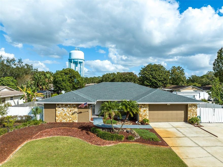 Expect to be impressed with this updated and well-maintained 4BR home in desirable Sand Lake Hills. Major recent updates include: (1) new water heater (2023), (2) upgraded electrical panel (2019), (3) new A/C (2018) and (4) new roof (2016).  As soon as you arrive, you’ll know you are about to experience something special - great curb appeal – meticulously manicured lawn and attractively designed landscaping. Step inside to open common living space – living area, kitchen and dining room. Contemporary kitchen boasts granite counters, oversized island w/breakfast bar, abundant cabinet space and room to add a table for casual dining. The adjacent formal dining room is large enough to seat a crowd and features highly polished wood flooring.  The living area make a great gathering space and has a striking brick accent wall.  There’s a split bedroom plan, with the master suite conveniently located off the living area. It features a stunningly updated master bath w/shower and walk-in closet. You’ll appreciate having a shower w/multiple heads. The expansive dual sink vanity is granite topped and has plenty of storage space. Remaining bedrooms and bath are tucked off the home’s hallway. Across the back of the home you will find a HUGE Florida room under A/C. The wall of windows fills the space with light. It’s a wonderfully versatile spot – use as office space, an exercise area, a hobby center, a secondary entertainment spot – endless possibilities. And there’s a 13x6 room off this space that’s ideal for storage. One additional reason to love this home is all that you have out back – a hot tub (240 volt) and a backyard that has a park-like feel, with paved paths leading to two patio spaces, a central green space and lush landscaping all around. This area is fully fenced, giving you privacy while you enjoy your fun in the sun. Other notable features include a 21x 16 work building with electricity (120/240 voltage), a separate supply panel, and a compressor-welding outlet. There’s also a parking pad that’s long enough to accommodate an RV. Great location - Sand Lake Hills is a well-established neighborhood in the highly sought after Dr. Phillips community. It’s in a good school district, and you’re only about a mile from all the shopping and dining venues along Sand Lake Rd. No HOA, so no restrictions! This home has been lovingly cared for by the same family for decades. It’s now time for you to make some new memories here. Come see all that this home has to offer!